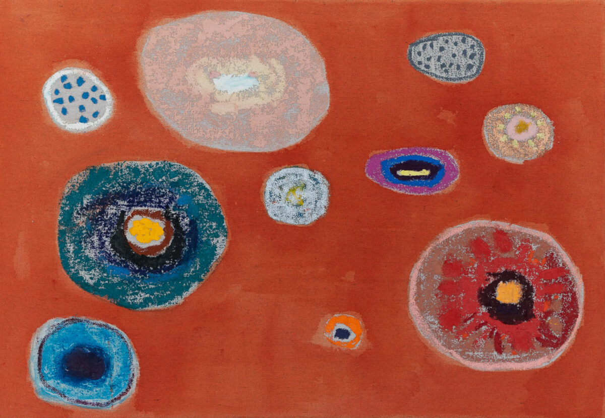 A vibrant red-orange canvas populated with concentric circular forms in varying sizes, rendered in blues, teals, whites, pinks, and earth tones. Each circle contains layered rings with contrasting colors and textured surfaces, creating an organic, cellular appearance against the warm monochromatic background.