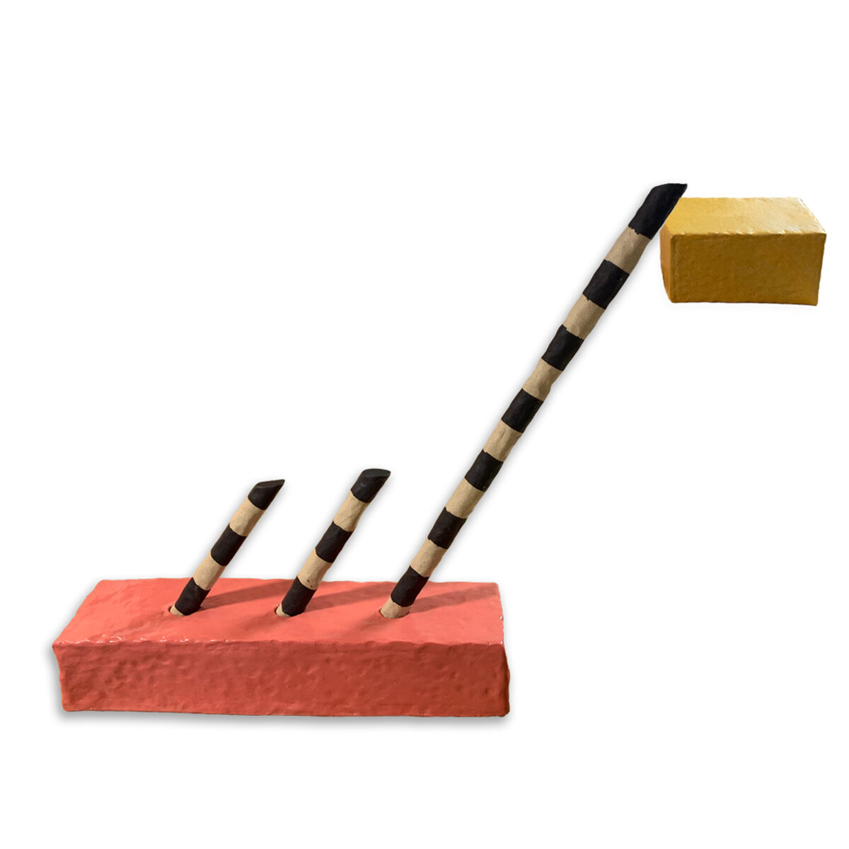 Three striped wooden tools with black and natural wood bands lean at increasing angles against a red-brown rectangular base, with a gold-colored rectangular form positioned at the top right, creating a geometric composition in earthy tones.