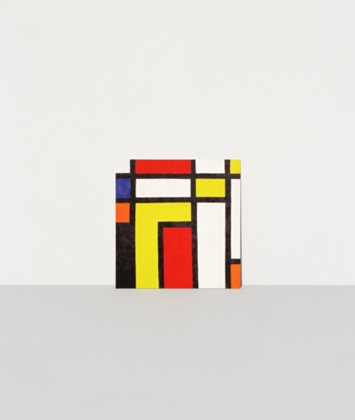 Abstract geometric composition featuring intersecting rectangular forms in red, yellow, blue, orange, and white, arranged against a neutral background in the style of modernist painting.