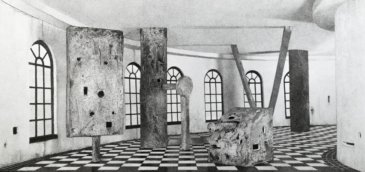 Black and white architectural interior with weathered concrete columns and walls featuring a geometric checkerboard floor. Multiple arched windows with grid patterns line the space, while irregular holes and openings punctuate the surfaces, creating an ambiguous sense of decay or deliberate abstraction.