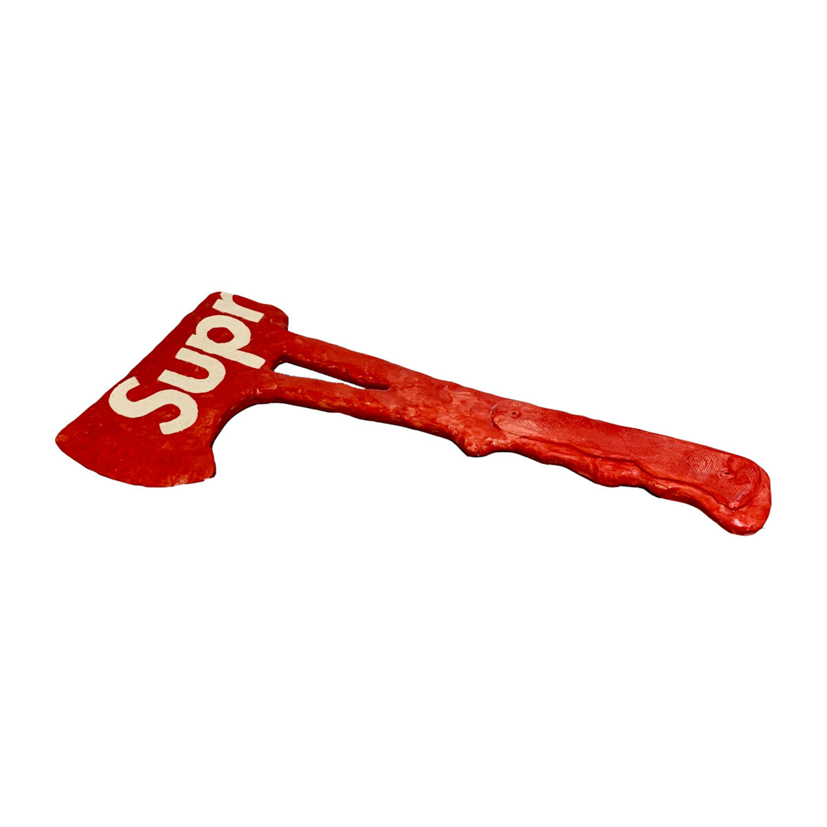Red ceramic hatchet with cream-colored lettering on the blade, featuring a textured wooden handle rendered in glazed clay.
