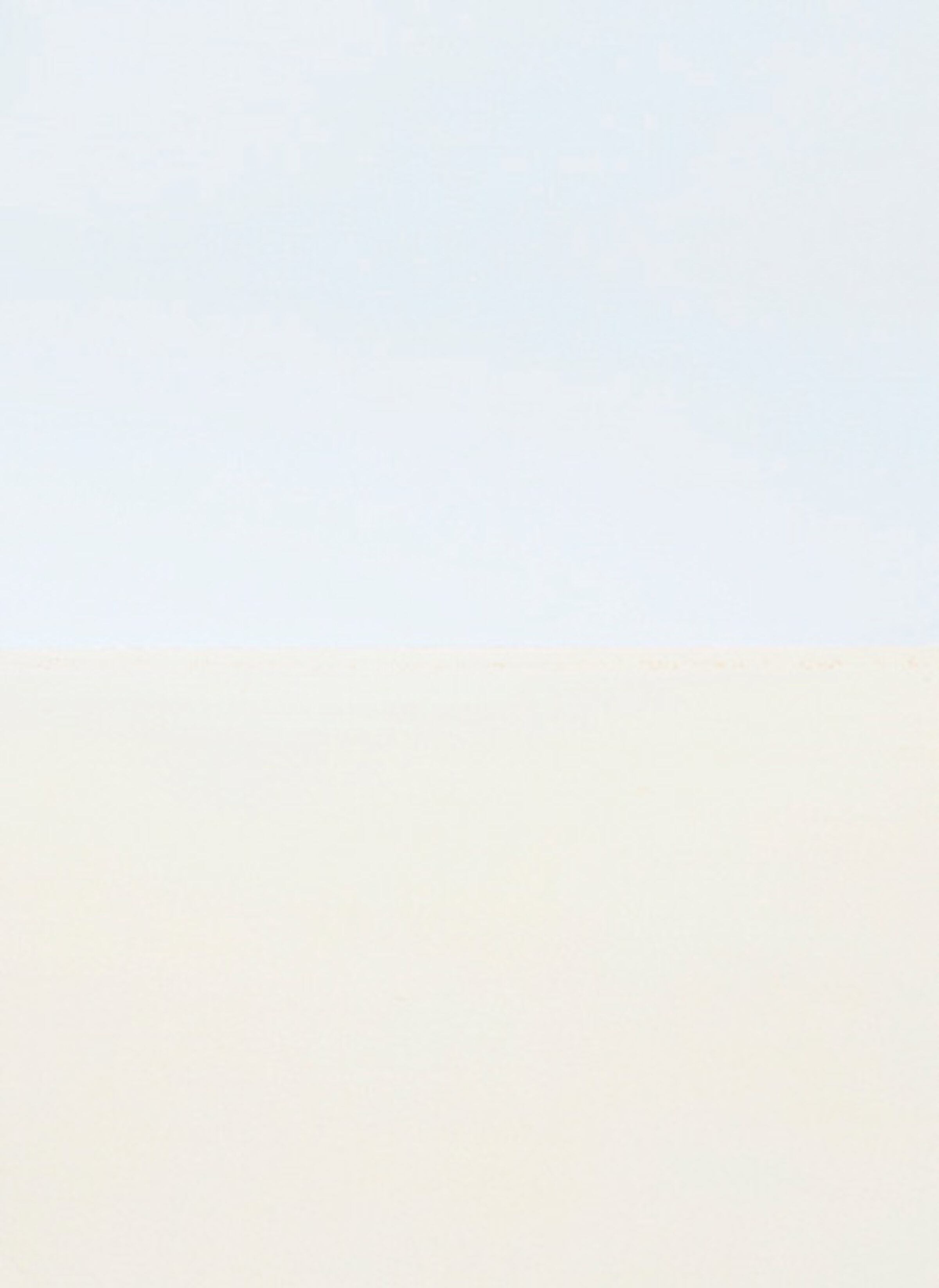 Minimalist composition divided horizontally into two soft color fields—pale blue-gray above and warm beige below—creating a serene, atmospheric study in subtle tonal gradation.