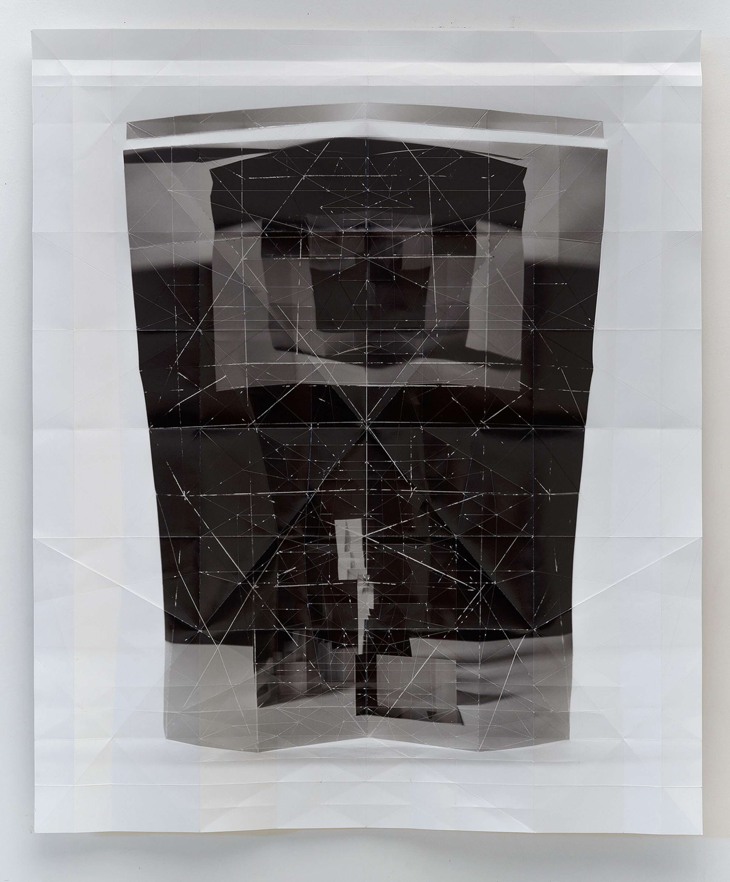 Layered folded inkjet print featuring overlapping translucent and opaque sections in black, white, and gray tones. A geometric wireframe pattern of connected lines and points overlays the composition, creating a complex three-dimensional effect across the folded paper planes.
