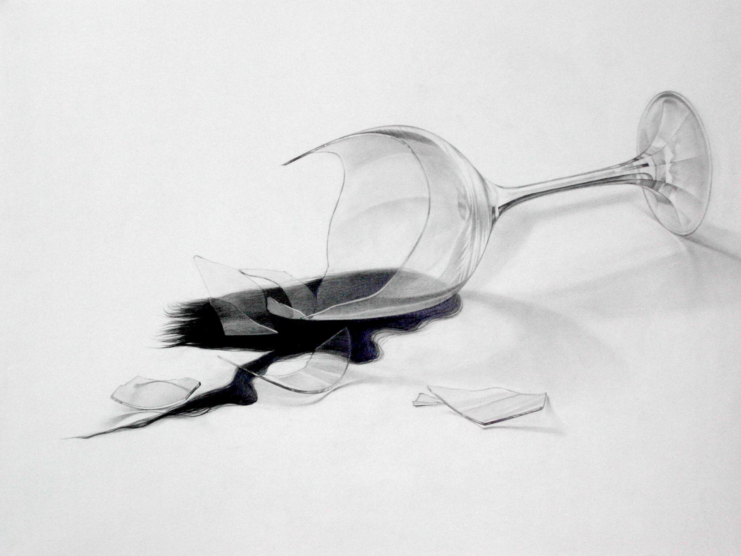 A tipped-over wine glass with dark liquid spilling across a white surface, rendered in graphite with careful attention to transparency, reflection, and shadow. Broken glass shards scatter nearby, creating a study in contrast between the delicate clarity of the glass vessel and the bold, gestural marks of the spilled liquid.