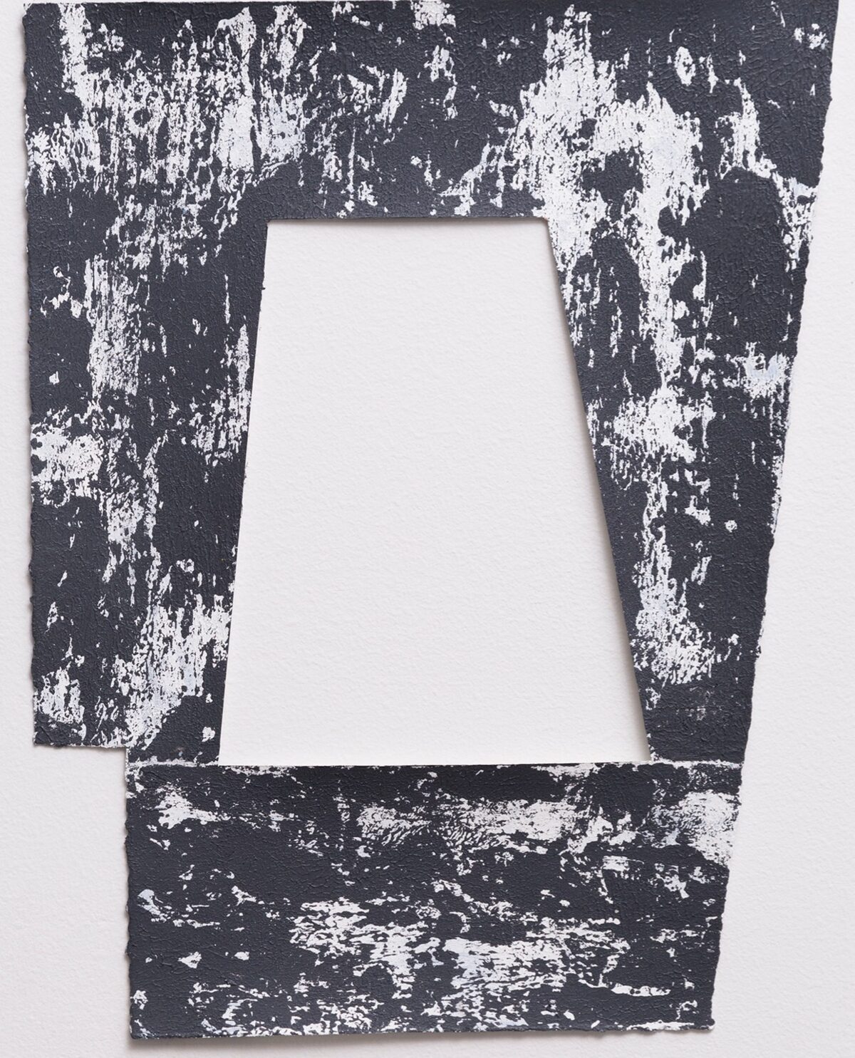 A distressed frame composition with a central white trapezoid aperture surrounded by heavily textured dark charcoal and white paint creating an aged, deteriorated surface effect. The irregular splattering and chipping across the entire work creates a sense of decay and layered abstraction.