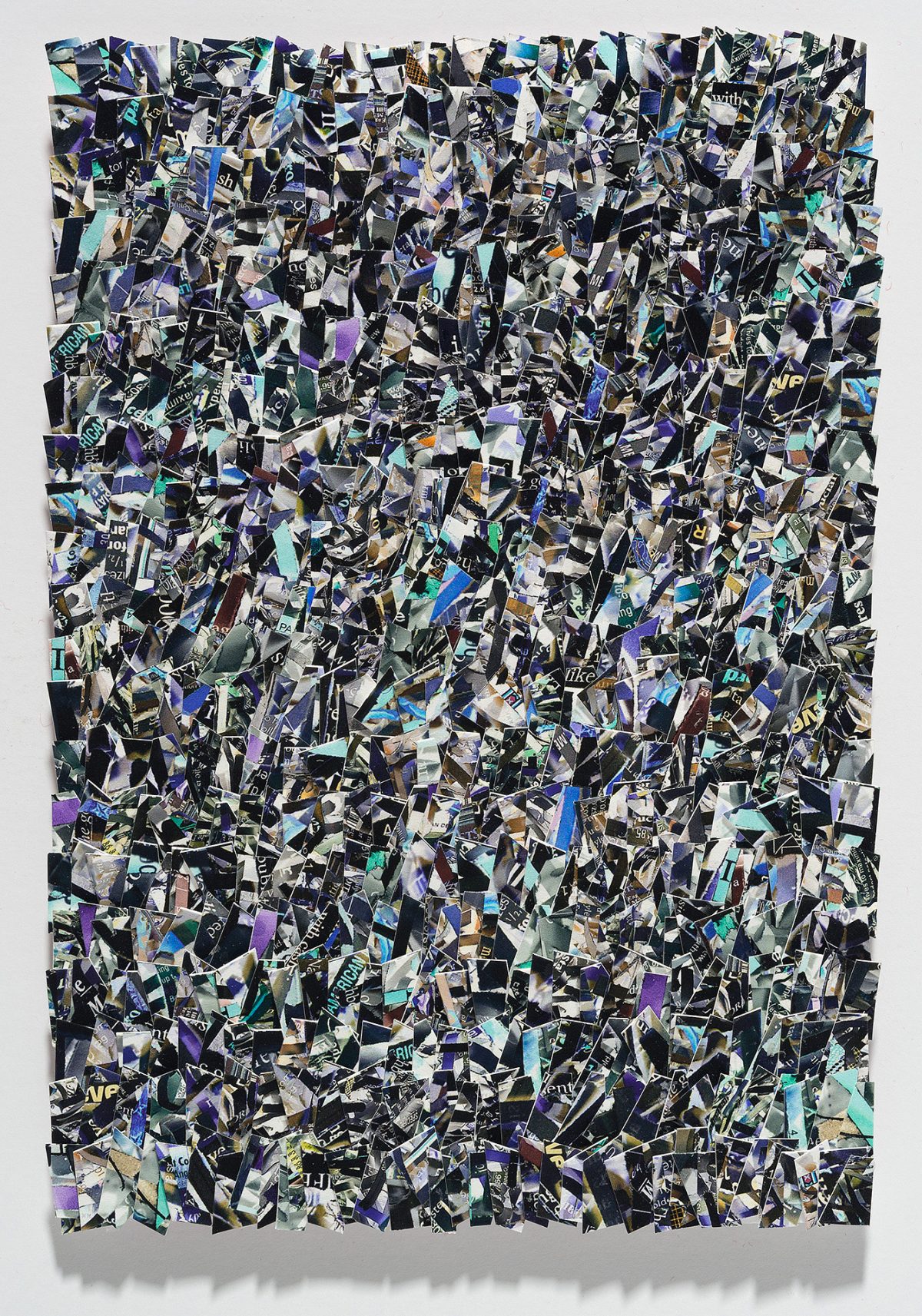 A densely layered collage of hundreds of torn and overlapping printed fragments in shades of black, white, purple, blue, cyan, and gold, creating an all-over abstract composition with no clear focal point. The irregular paper pieces are arranged in a chaotic, non-representational pattern across a rectangular format, with visible text and imagery fragments scattered throughout the surface.
