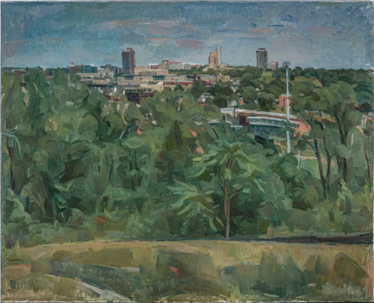 A cityscape viewed across a lush, verdant foreground of trees and vegetation. The composition stretches from densely rendered green foliage in the immediate foreground to a distant urban skyline dominated by mid-rise buildings and church spires. The painting employs muted blues and greens with warm tan and brick tones, rendered in loose, expressive brushwork characteristic of early modernist landscape painting.