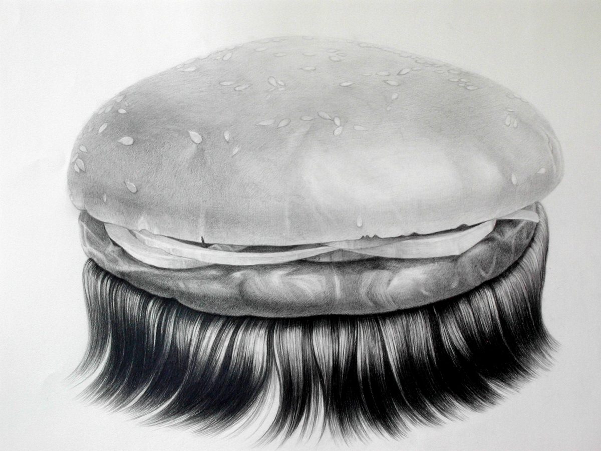 A detailed graphite drawing of a hamburger with a seeded bun, rendered in black and white. The bun sits atop a layer of meat and cheese, with long, flowing black hair cascading down from the bottom half like a beard or mane, creating an absurdist contrast between the food subject and the organic, human-like hair.