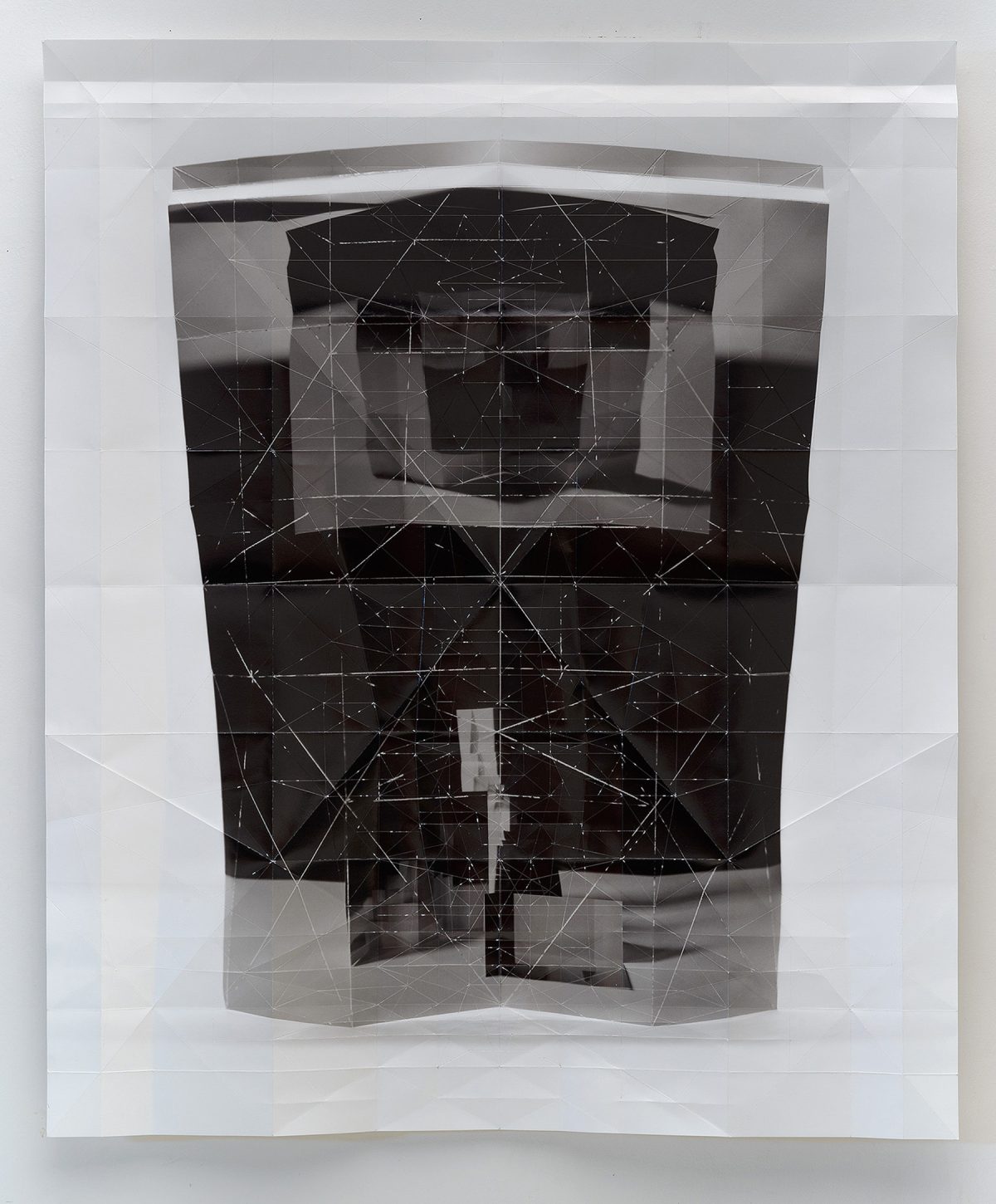Layered folded inkjet print featuring overlapping translucent and opaque sections in black, white, and gray tones. A geometric wireframe pattern of connected lines and points overlays the composition, creating a complex three-dimensional effect across the folded paper planes.