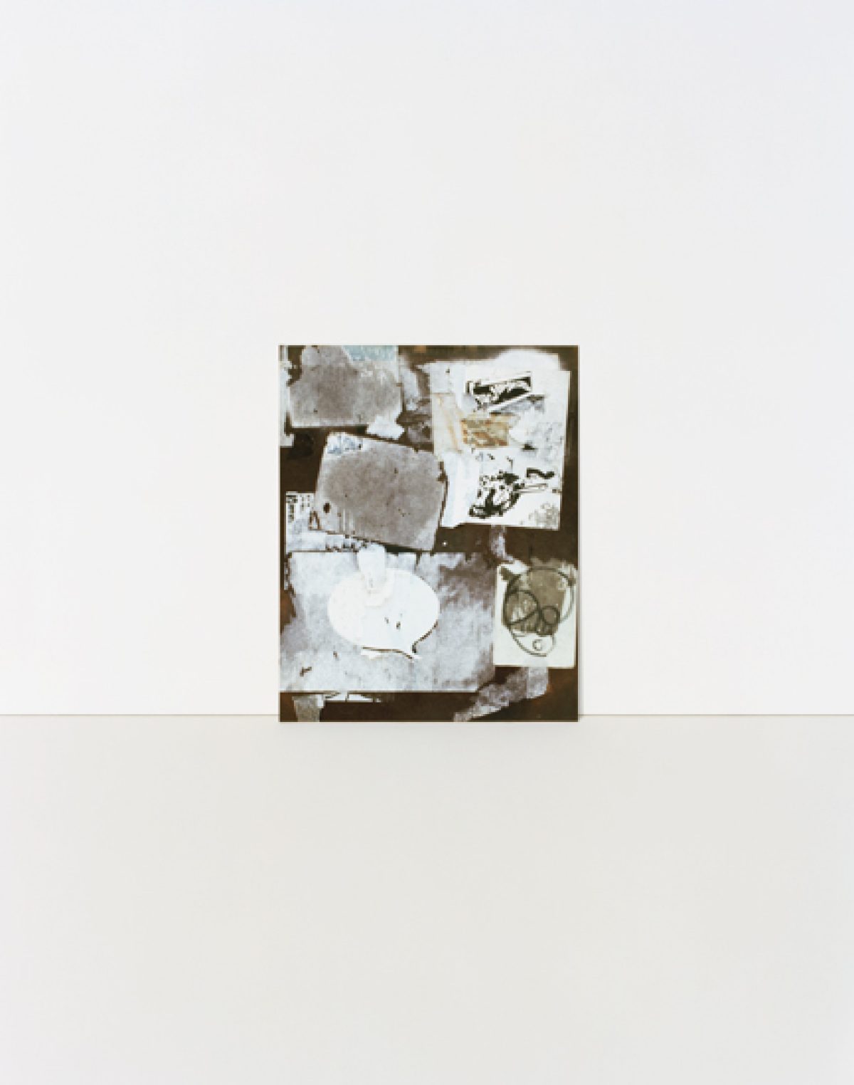 A mounted photograph featuring layered, translucent white and cream-colored papers with handwritten text and sketches arranged on a dark brown background. The composition is vertical with overlapping rectangular forms creating depth and texture through their varied opacity and positioning.