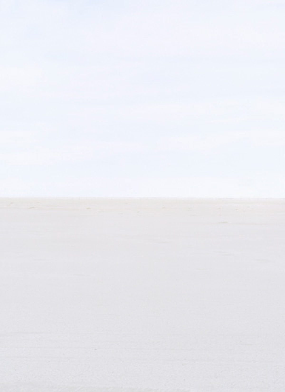 Minimalist composition divided horizontally into two tonal zones—a pale blue-gray upper section meeting a lighter beige-white lower section at a subtle horizon line. The soft, monochromatic palette and gentle gradations create a serene, atmospheric landscape.