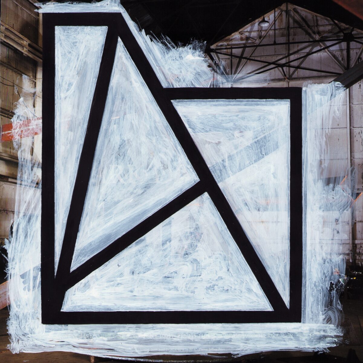Abstract composition featuring bold black lines forming geometric shapes against a white textured background, with visible layered surfaces and industrial architecture visible at the edges of the frame.