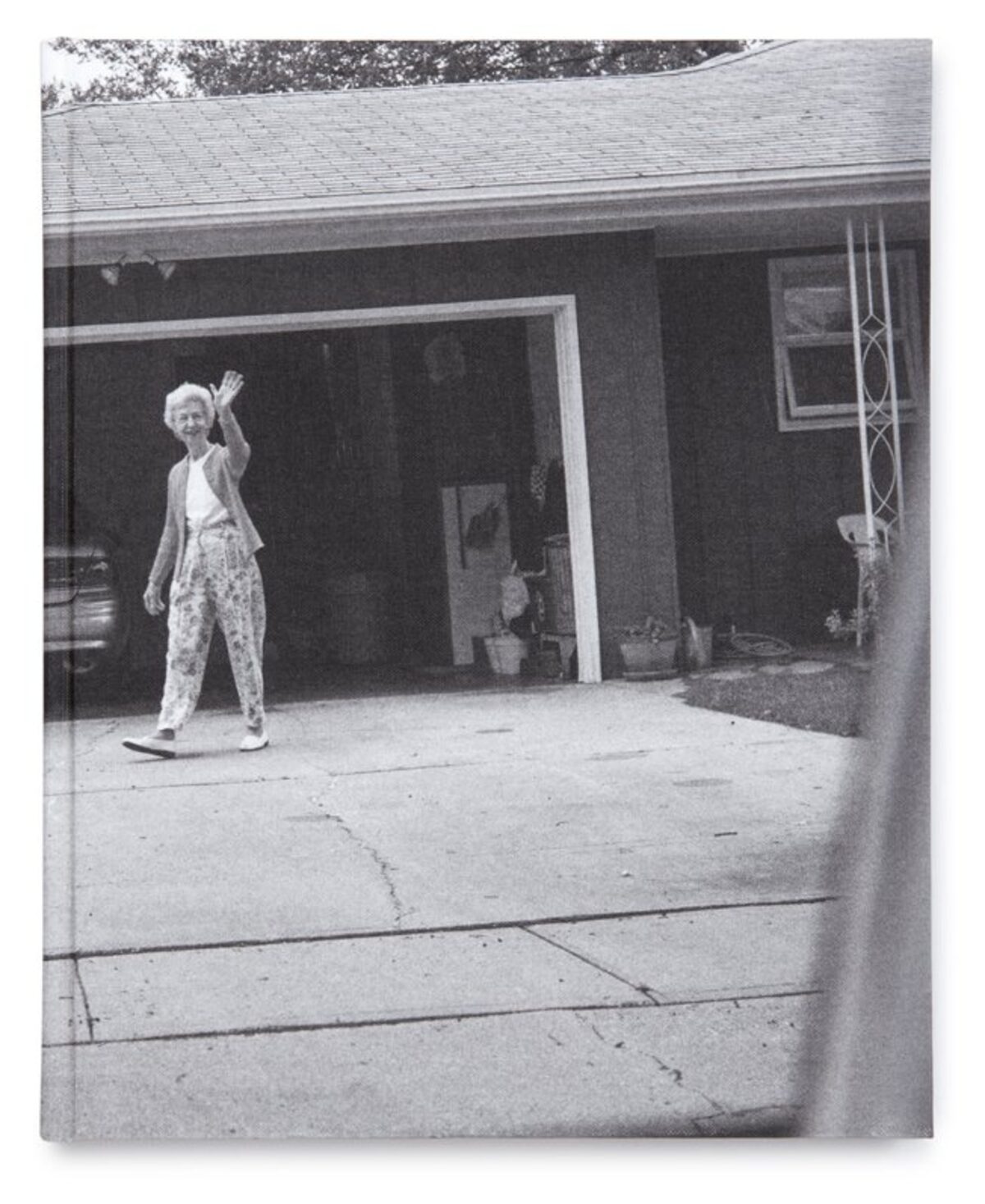 Front cover of Leaving and Waving by Deanna Dikeman, showing a black-and-white photograph of her parents outside their home.