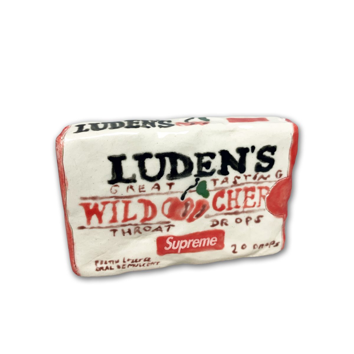 A ceramic cough drop box rendered in clay with glazed surface, featuring vintage packaging design with red and black typography on cream-colored ground. The work mimics a vintage Luden's Wild Cherry throat drops box, complete with period-accurate graphics and text details.
