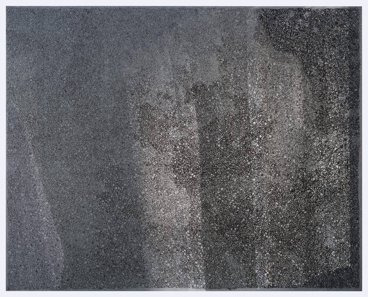 A grayscale composition with granular texture throughout, featuring vertical striations and concentrated dark passages that create depth across the surface. The work demonstrates a subtle interplay between dense, speckled areas and lighter zones, suggesting an atmospheric or reflective quality.
