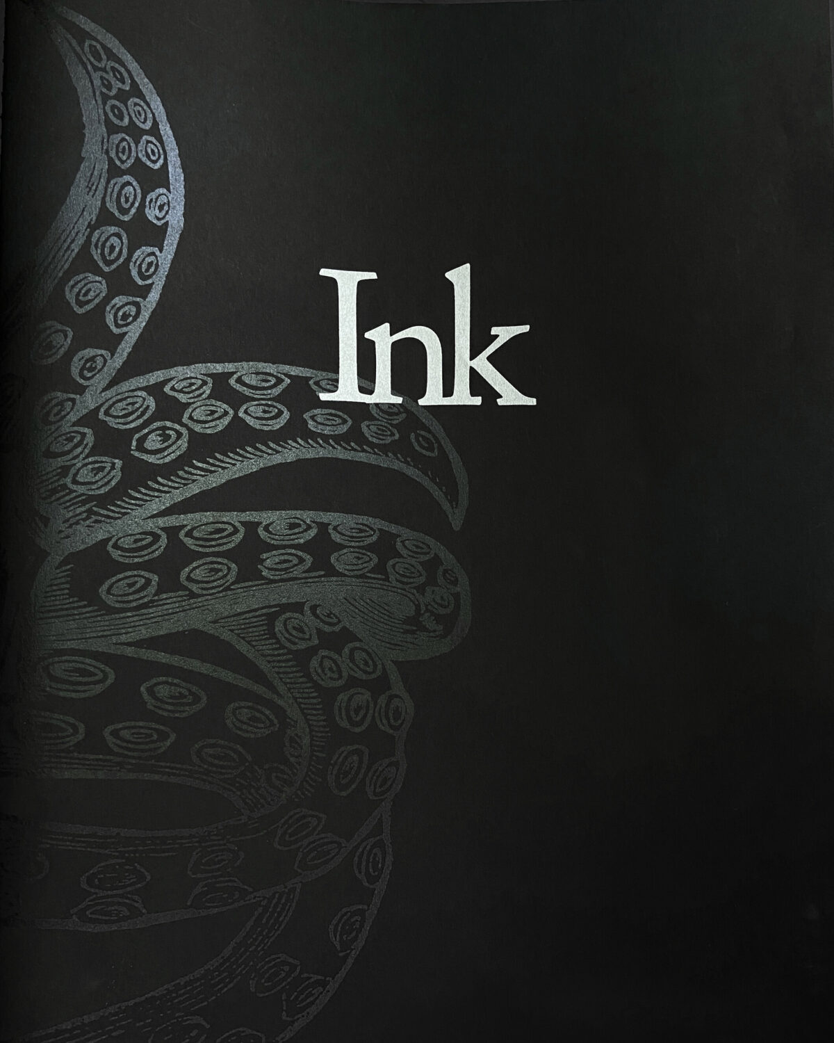 Black front cover of INK by Tanya Marcuse, with white lettering and a gray illustration of squid tentacles.