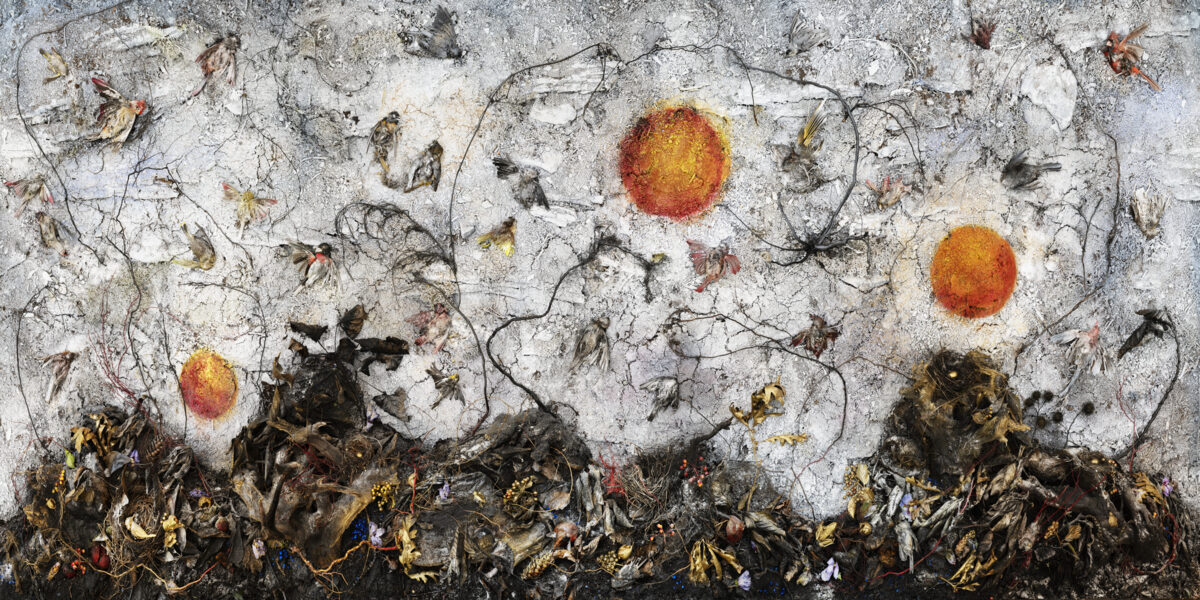 White textured surface scattered with delicate dried plant stems and botanical debris, punctuated by three luminous circular forms in shades of red-orange and yellow. Dense clusters of darkened organic matter accumulate along the bottom edge, creating a stark contrast with the ethereal upper composition.
