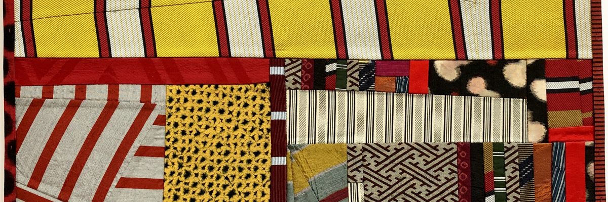 Layered textile collage composed of striped, patterned, and solid fabric pieces in red, yellow, cream, black, and earth tones, arranged in an abstract composition with visible stitching creating depth and texture throughout.