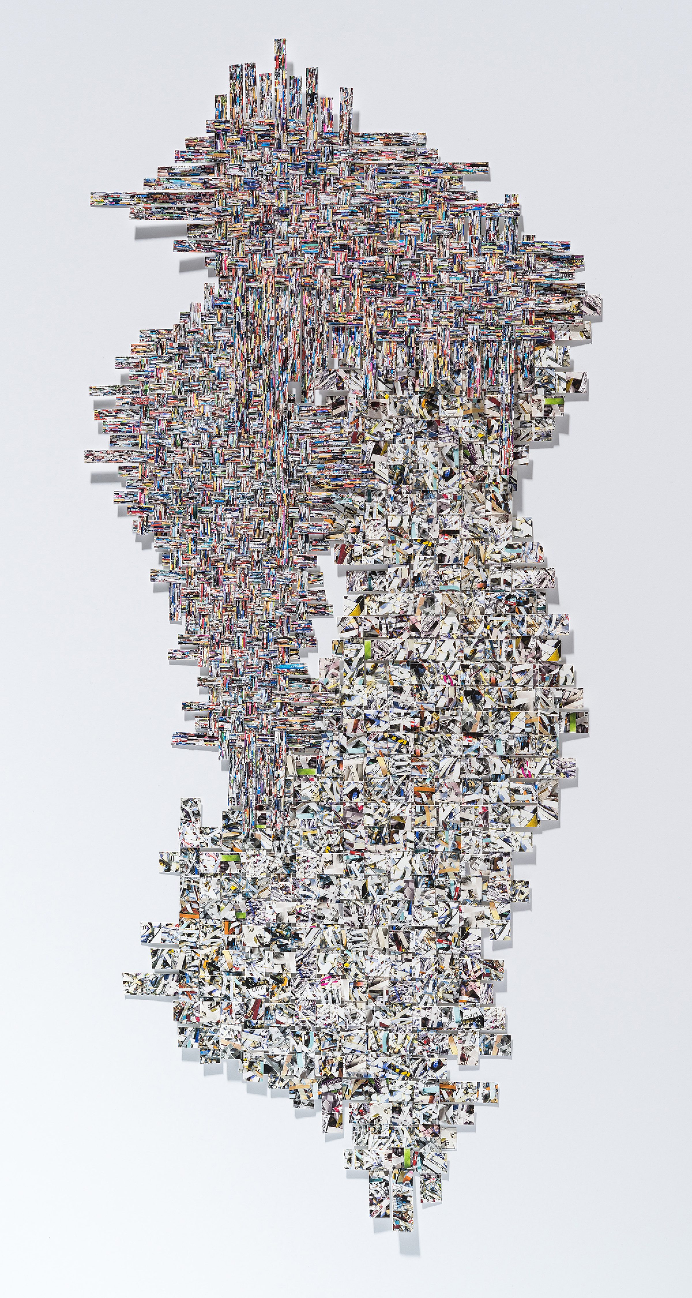 A vertical collage composed of hundreds of small photographic fragments arranged in a dense, organic pattern. The upper portion features tightly layered colorful images creating an intricate woven texture, while the lower half transitions to predominantly white and grayscale fragments that taper toward the bottom, creating a cascading effect against a white background.