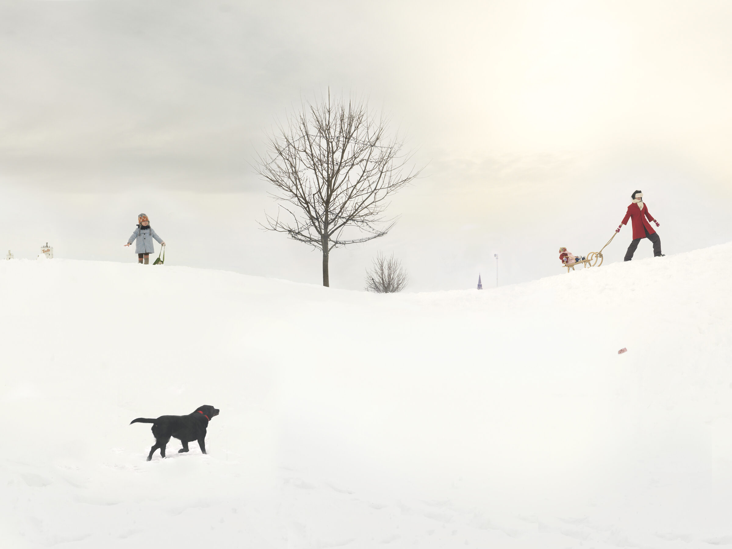 A snowy landscape with figures scattered across a white field. A bare tree stands in the center, while a person in a blue coat holds a basket on the left, another in a red coat pulls a sled with a child on the right, and a black dog walks in the foreground. The composition is minimal and serene, with muted tones against the expansive white snow.