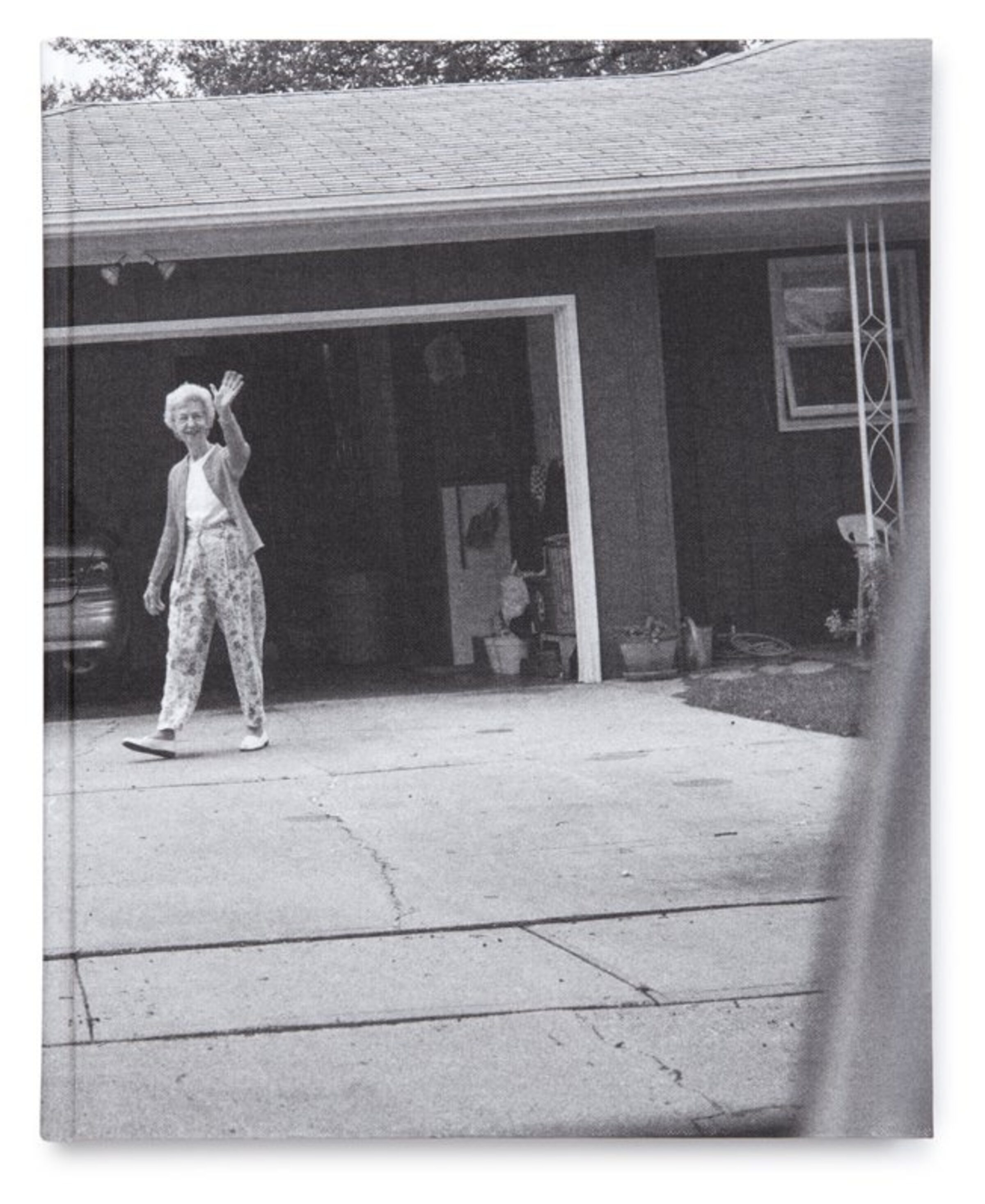 Front cover of Leaving and Waving by Deanna Dikeman, showing a black-and-white photograph of her parents outside their home.