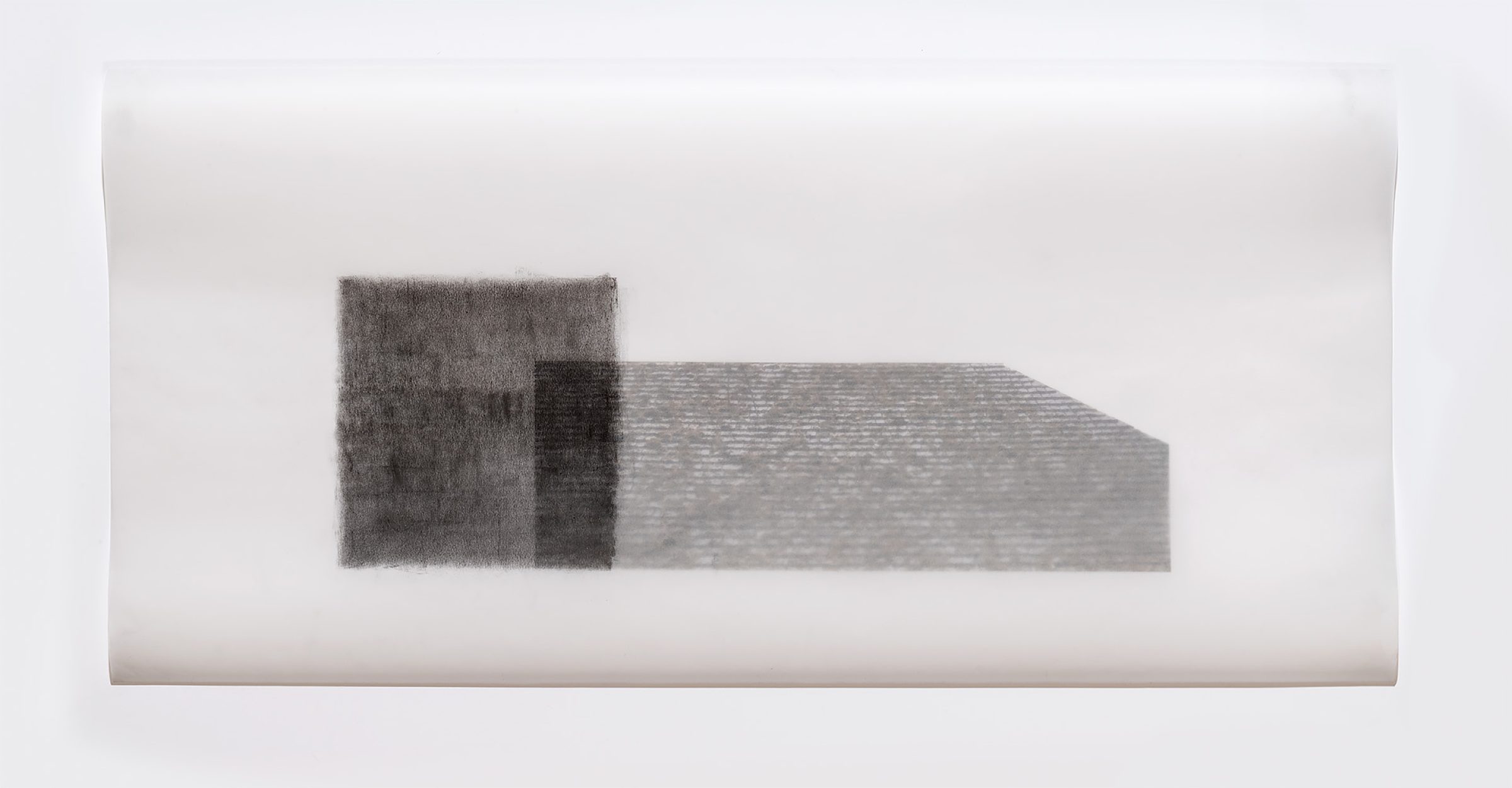 Two rectangular forms rendered in graphite on translucent vellum, positioned horizontally against a light background. The left form appears darker and more densely textured, while the right extends further with a lighter, linear pattern suggesting architectural detail or surface texture.