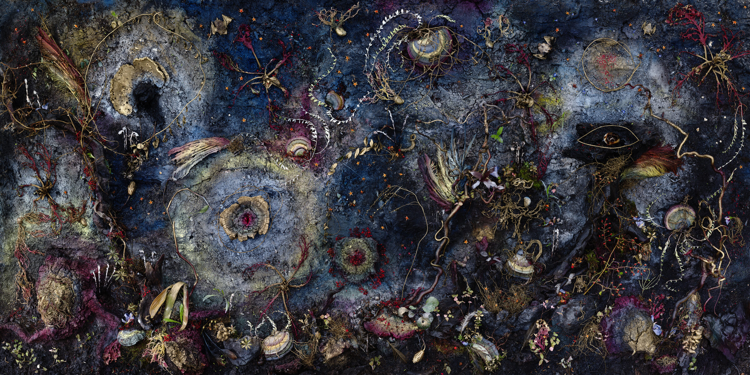 A richly textured composition featuring an intricate array of botanical and organic forms scattered across a deep blue background. Luminescent pigments create glowing accents throughout delicate tendrils, shells, eyes, and layered plant-like structures in shades of cream, gold, purple, and red, evoking both celestial and deep-sea imagery in an otherworldly, densely layered arrangement.