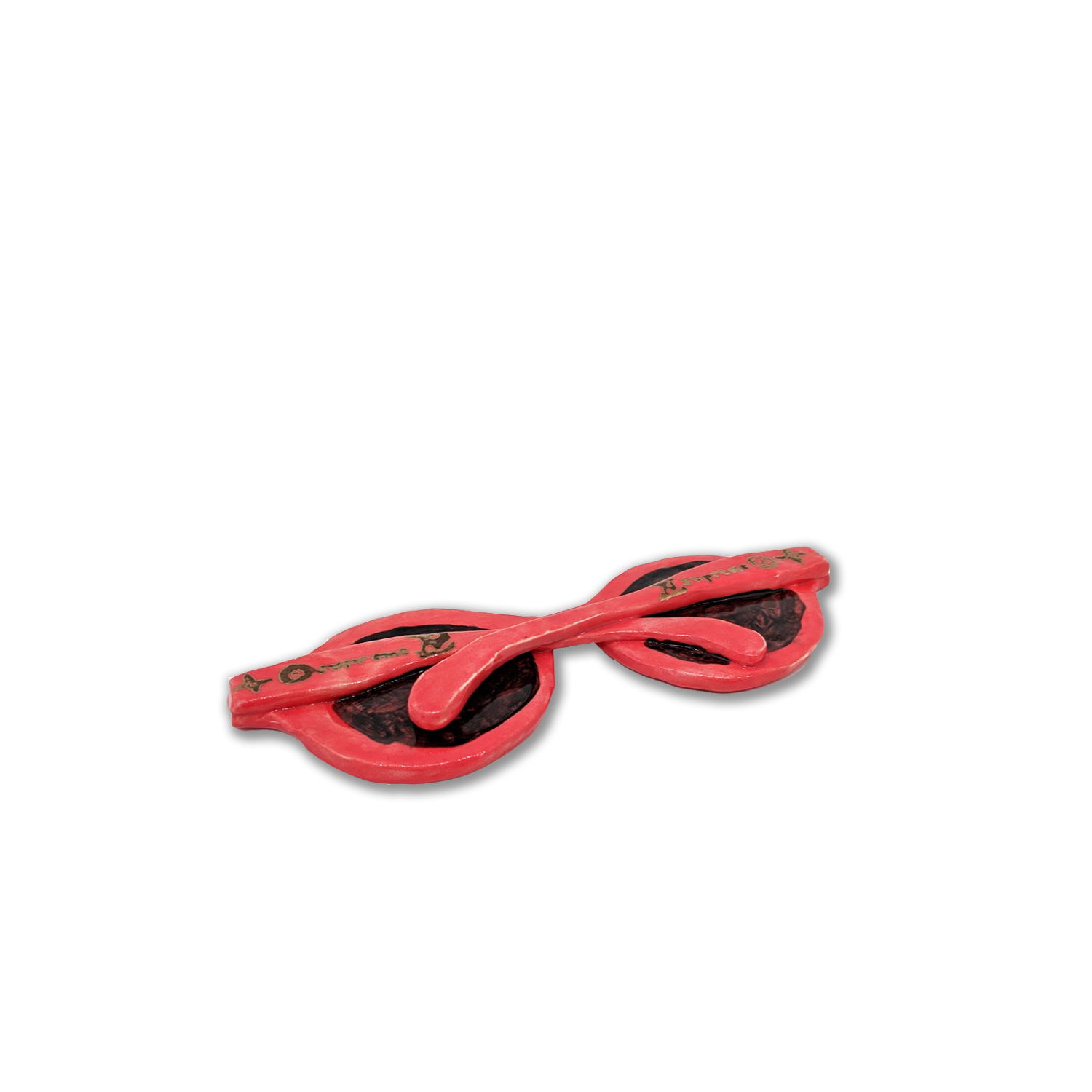 Bright red ceramic sunglasses with dark lenses and decorative gold detailing, displayed against a white background. The sculptural form features a glossy glazed surface with a curved, organic shape characteristic of functional eyewear.