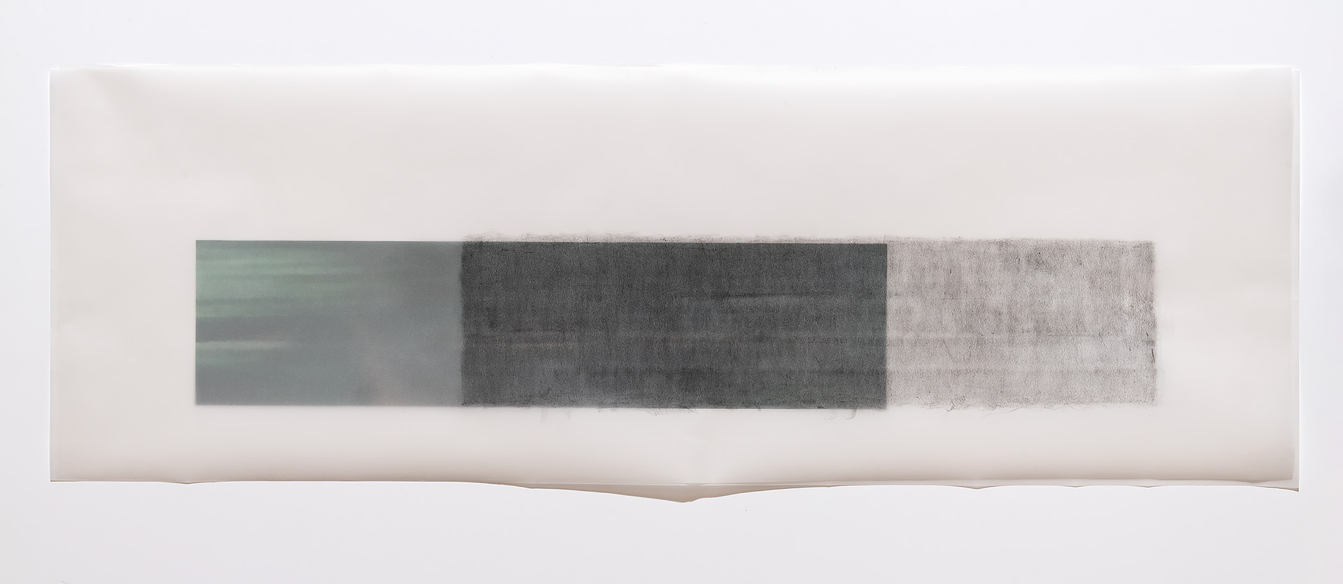 Horizontal composition featuring three rectangular panels in gradating shades of gray, from pale green-gray on the left through deep charcoal in the center to light silver-gray on the right, arranged on a cream-colored ground with subtle undulating edges.