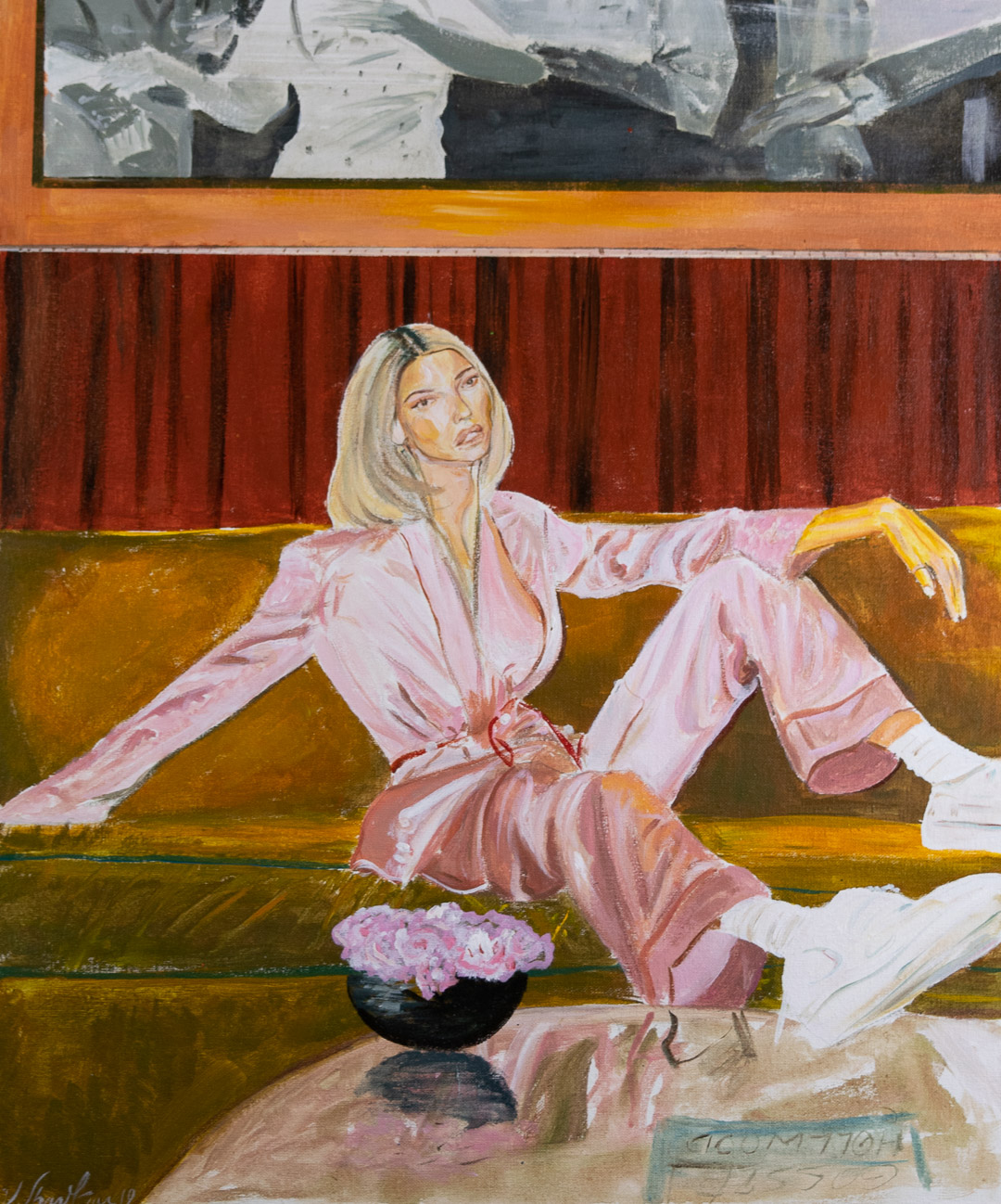 A figure in a pale pink suit reclines on a gold and burgundy striped sofa, gazing thoughtfully to the side. White sneakers rest on the floor beside a black bowl of pink flowers, while red velvet curtains and an orange-framed window with abstract imagery occupy the background.
