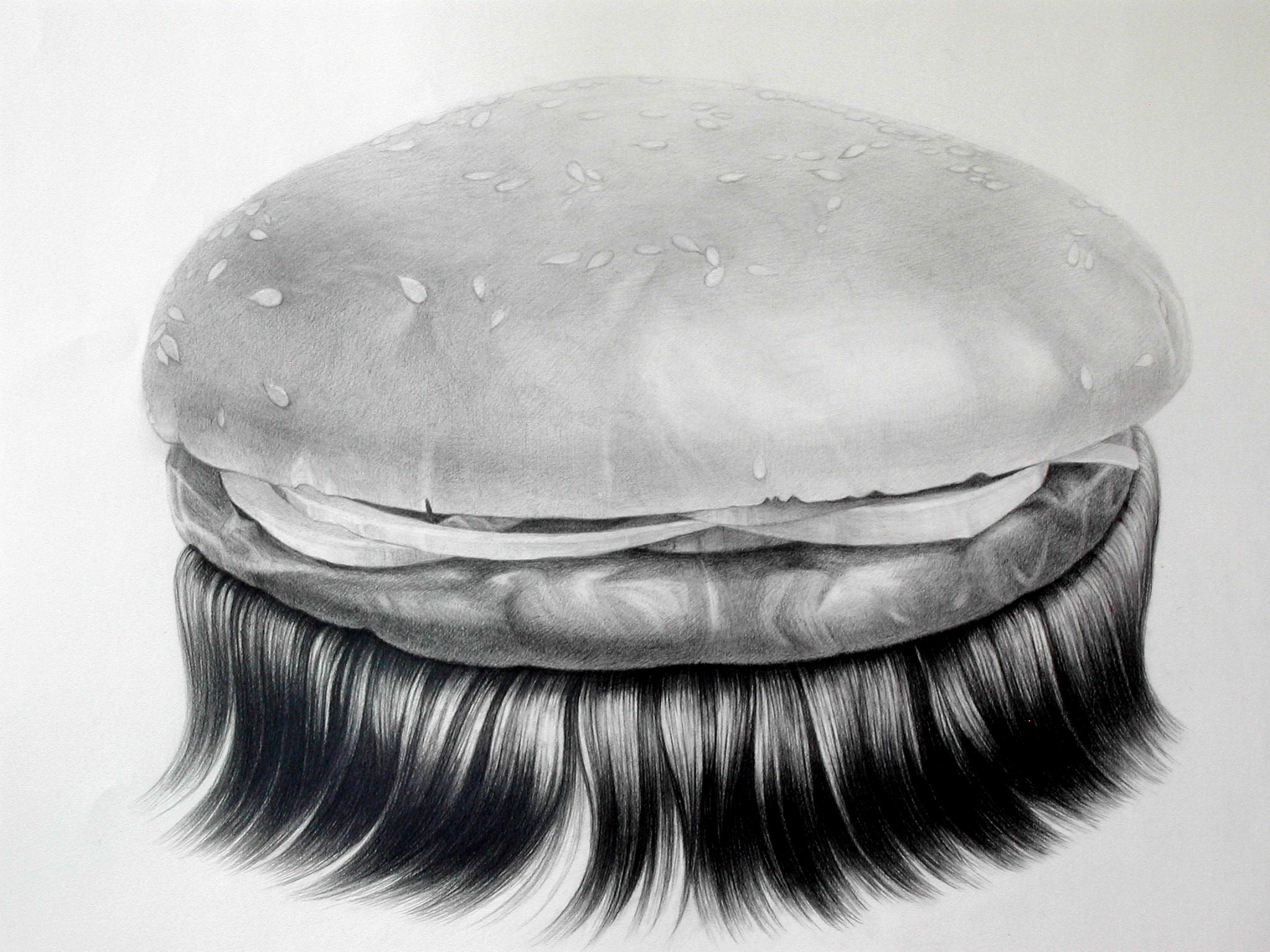 A detailed graphite drawing of a hamburger with a seeded bun, rendered in black and white. The bun sits atop a layer of meat and cheese, with long, flowing black hair cascading down from the bottom half like a beard or mane, creating an absurdist contrast between the food subject and the organic, human-like hair.