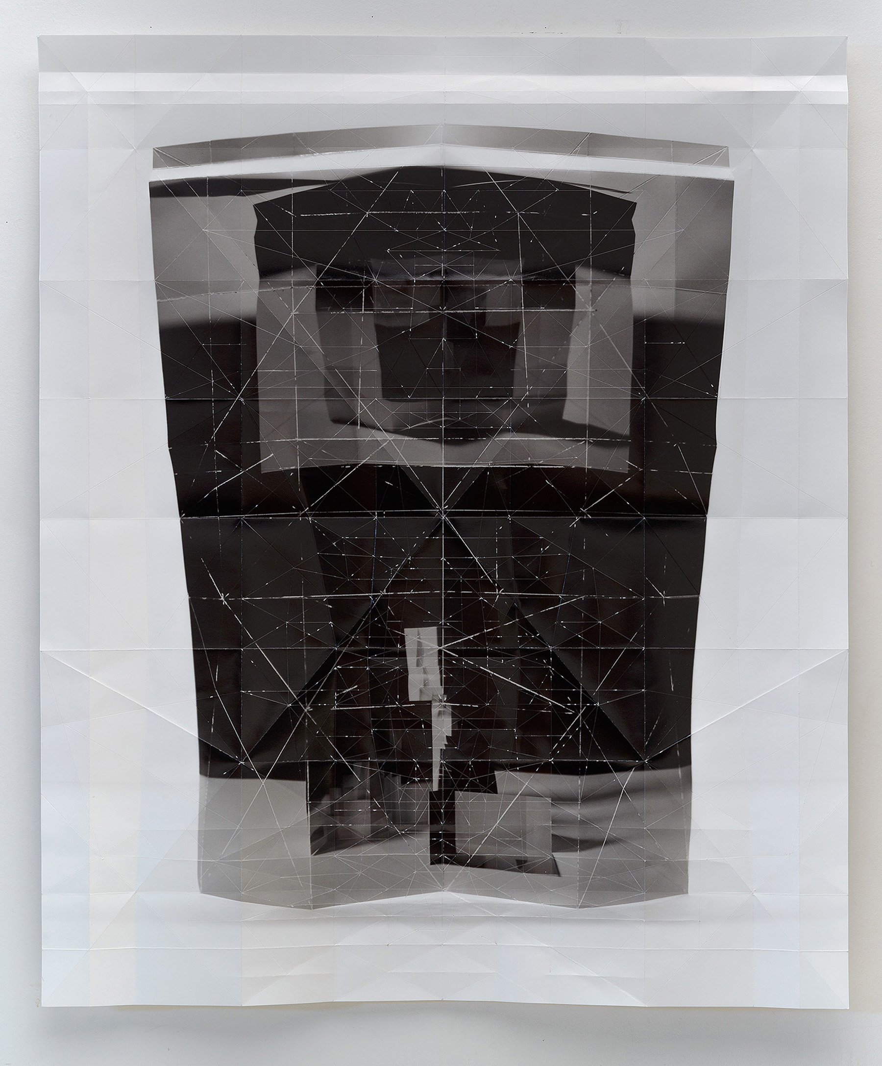 Layered folded inkjet print featuring overlapping translucent and opaque sections in black, white, and gray tones. A geometric wireframe pattern of connected lines and points overlays the composition, creating a complex three-dimensional effect across the folded paper planes.
