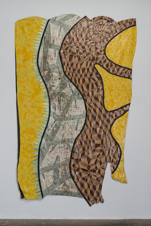 Abstract mixed-media composition featuring layered strips of patterned and textured materials in yellow, gray, and brown tones, arranged vertically with undulating edges and black outlines creating a dynamic, sculptural quality against a white wall.