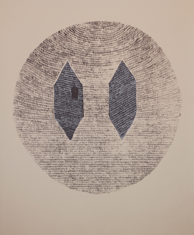 A spherical composition rendered in densely layered text or marks in graphite and silver ink, with two dark diamond-shaped voids positioned symmetrically within the center, creating an austere, mask-like appearance.