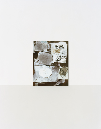 A mounted photograph featuring layered, translucent white and cream-colored papers with handwritten text and sketches arranged on a dark brown background. The composition is vertical with overlapping rectangular forms creating depth and texture through their varied opacity and positioning.