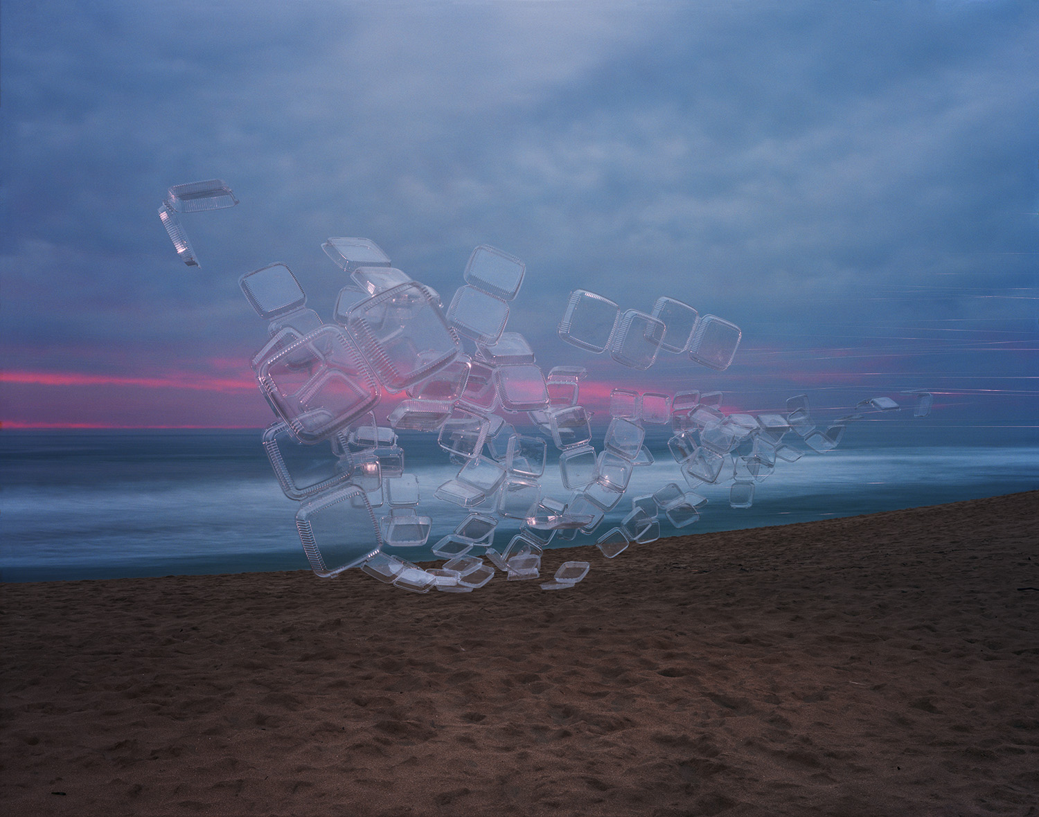 Translucent plastic takeout containers arranged in a sculptural pile on a beach at dusk, glowing with pink and blue light against a twilight sky and calm ocean horizon.