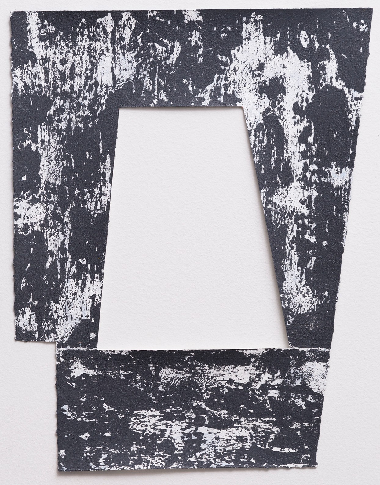A distressed frame composition with a central white trapezoid aperture surrounded by heavily textured dark charcoal and white paint creating an aged, deteriorated surface effect. The irregular splattering and chipping across the entire work creates a sense of decay and layered abstraction.