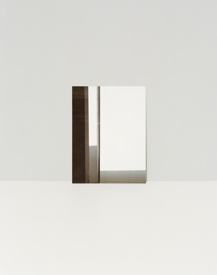 Minimalist composition featuring geometric forms in neutral tones—a dark brown vertical rectangle, light gray horizontal elements, and a white rectangular panel arranged against a pale beige background, creating subtle spatial depth through overlapping planes.