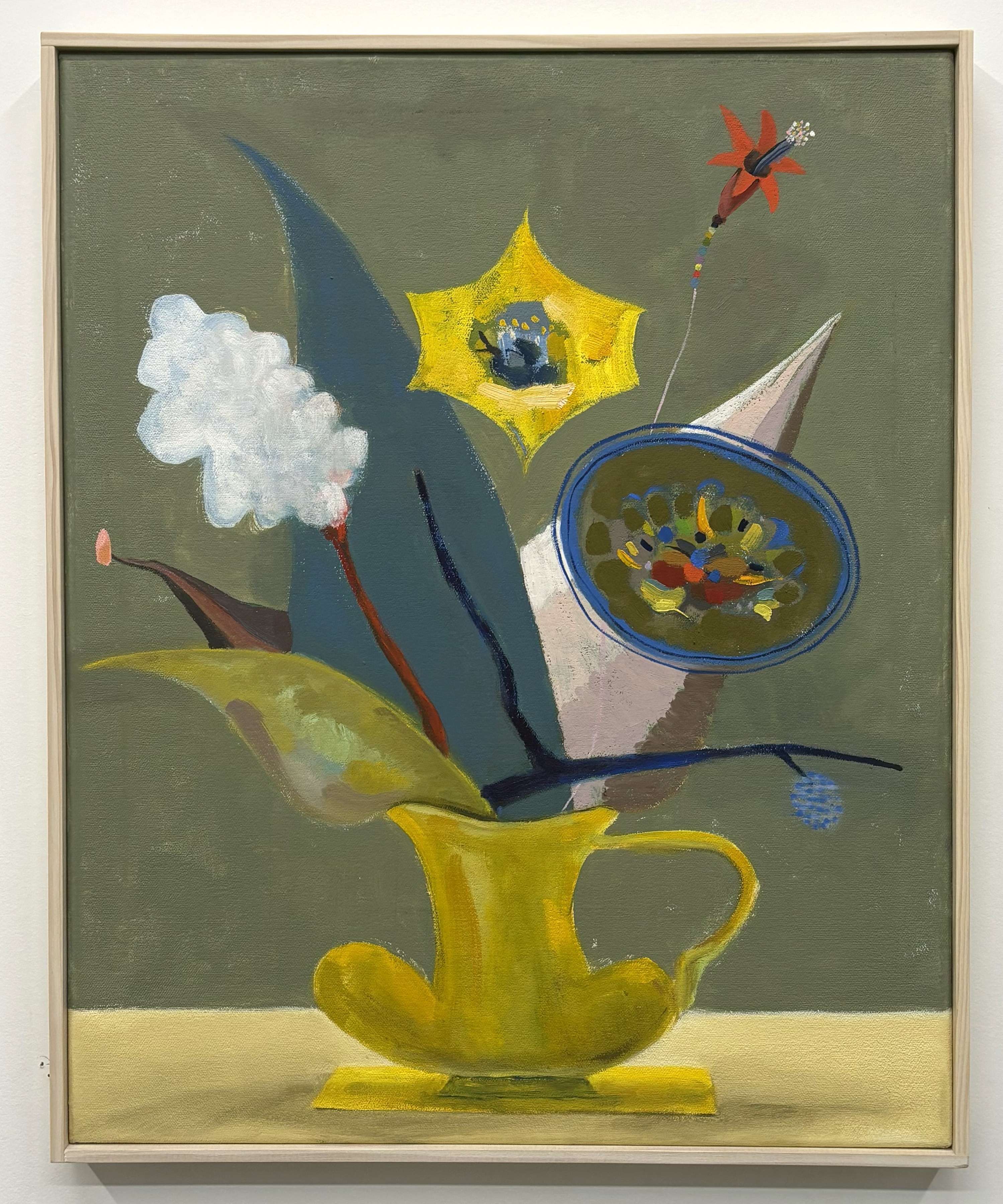 A surreal still life painting featuring a bright yellow pitcher as the central vessel, from which emerge various imaginative elements: a white fluffy form, dark blue curved shapes, a yellow star containing small figures, a blue-rimmed bowl with colorful objects, a red rocket, and other abstract forms against a muted green background.