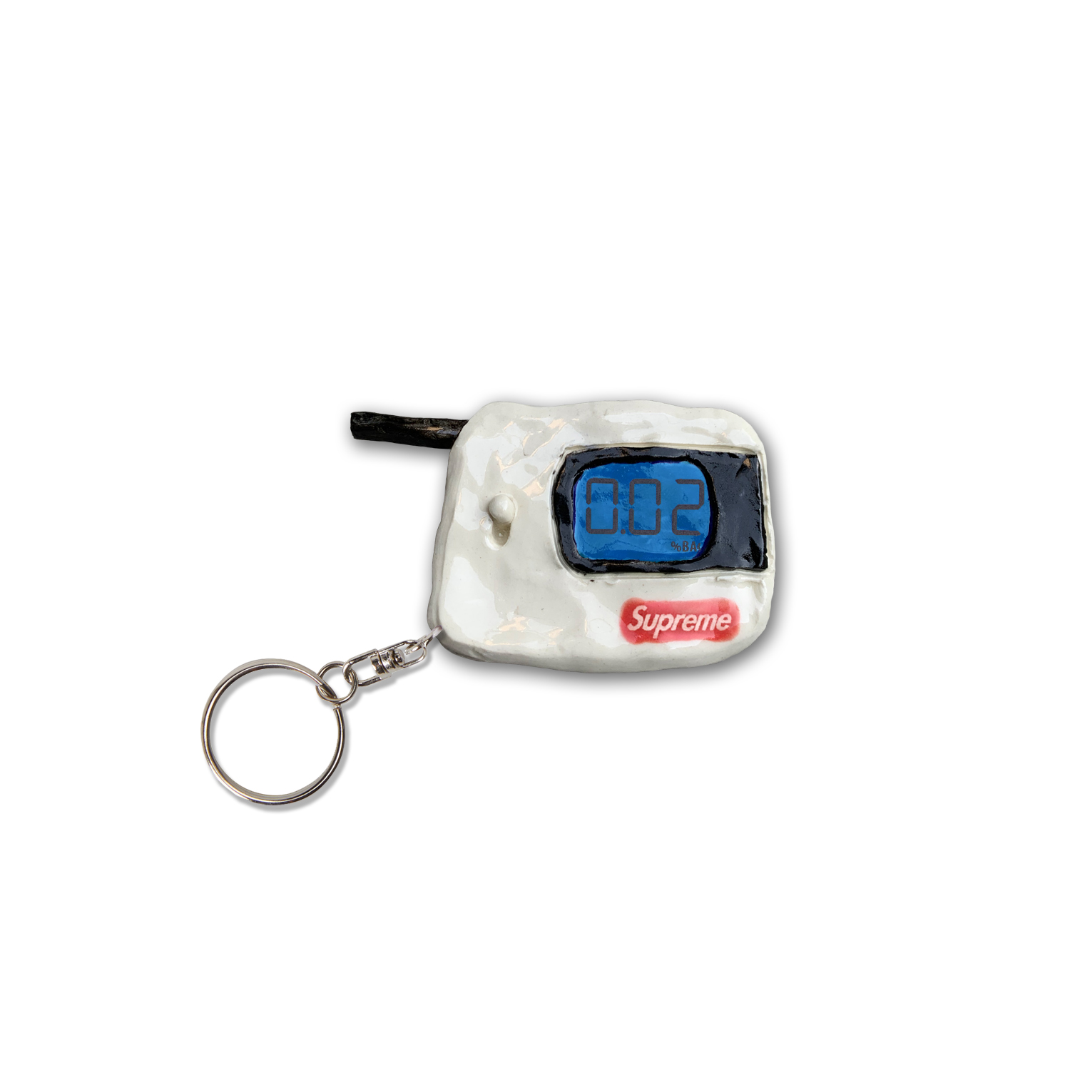 A white clay keychain featuring a blue digital display screen showing "002" and a red Supreme logo box below it, attached to a metal ring with a black cord loop extending from the top.