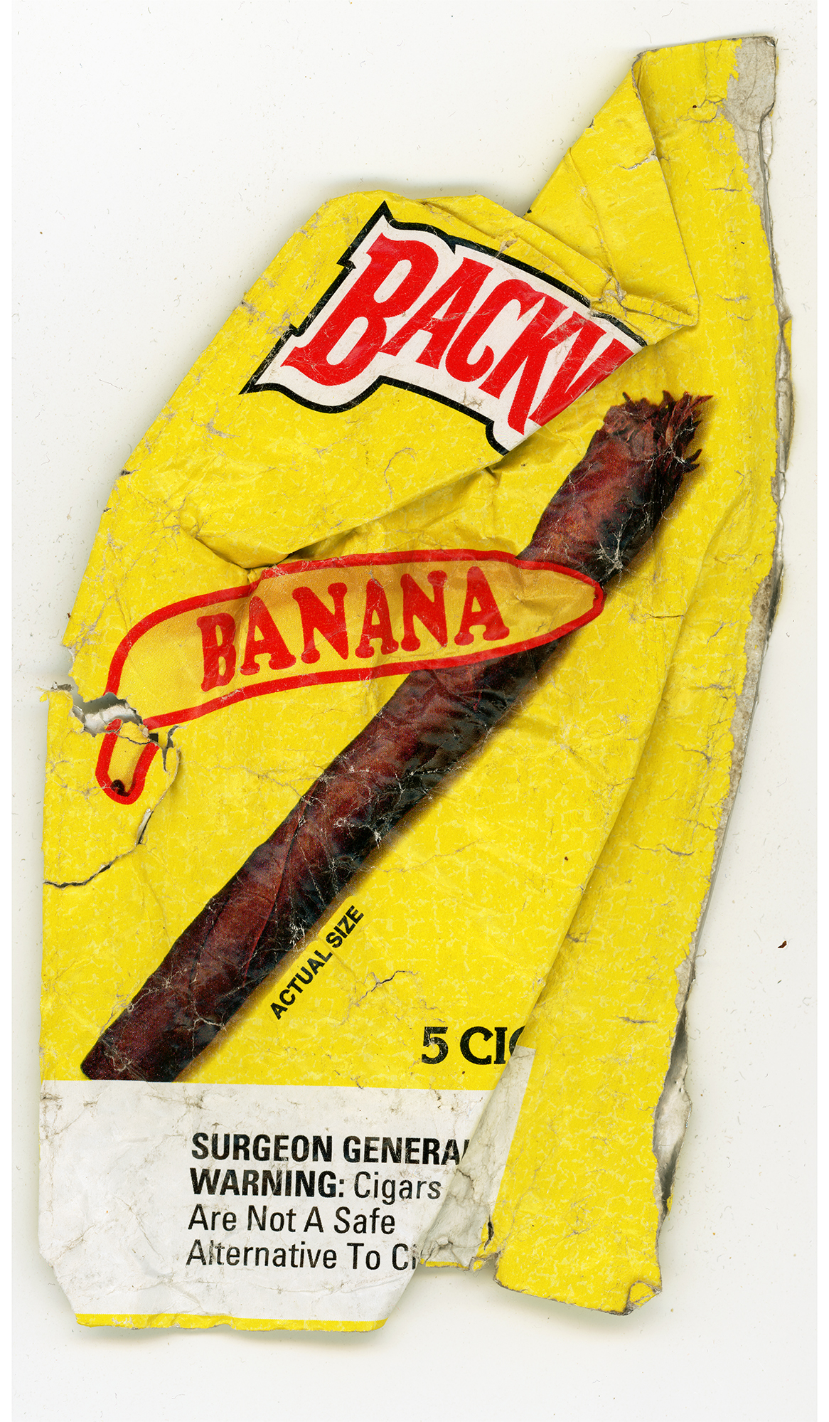 A bright yellow banana-shaped object with red and white text reading "BACK" and "BANANA" overlaid on its surface, featuring a photograph of an actual cigar in the center. A Surgeon General's warning label appears at the bottom in black text on a white background. The piece shows visible wear and creasing throughout.