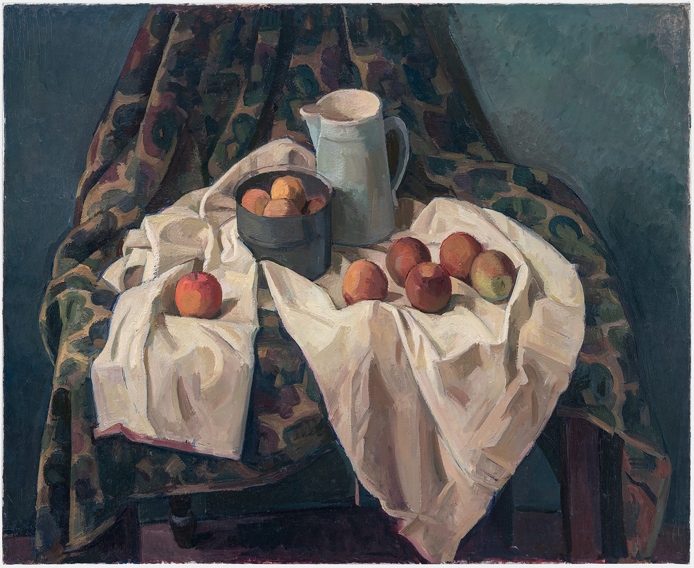 A still life composition featuring red and golden apples arranged on white draped fabric, with a dark bowl and gray ceramic pitcher set against a richly patterned dark textile backdrop. The painting employs warm earth tones and cool blues, with careful attention to the soft folds of the white cloth and the subtle modeling of the fruit.