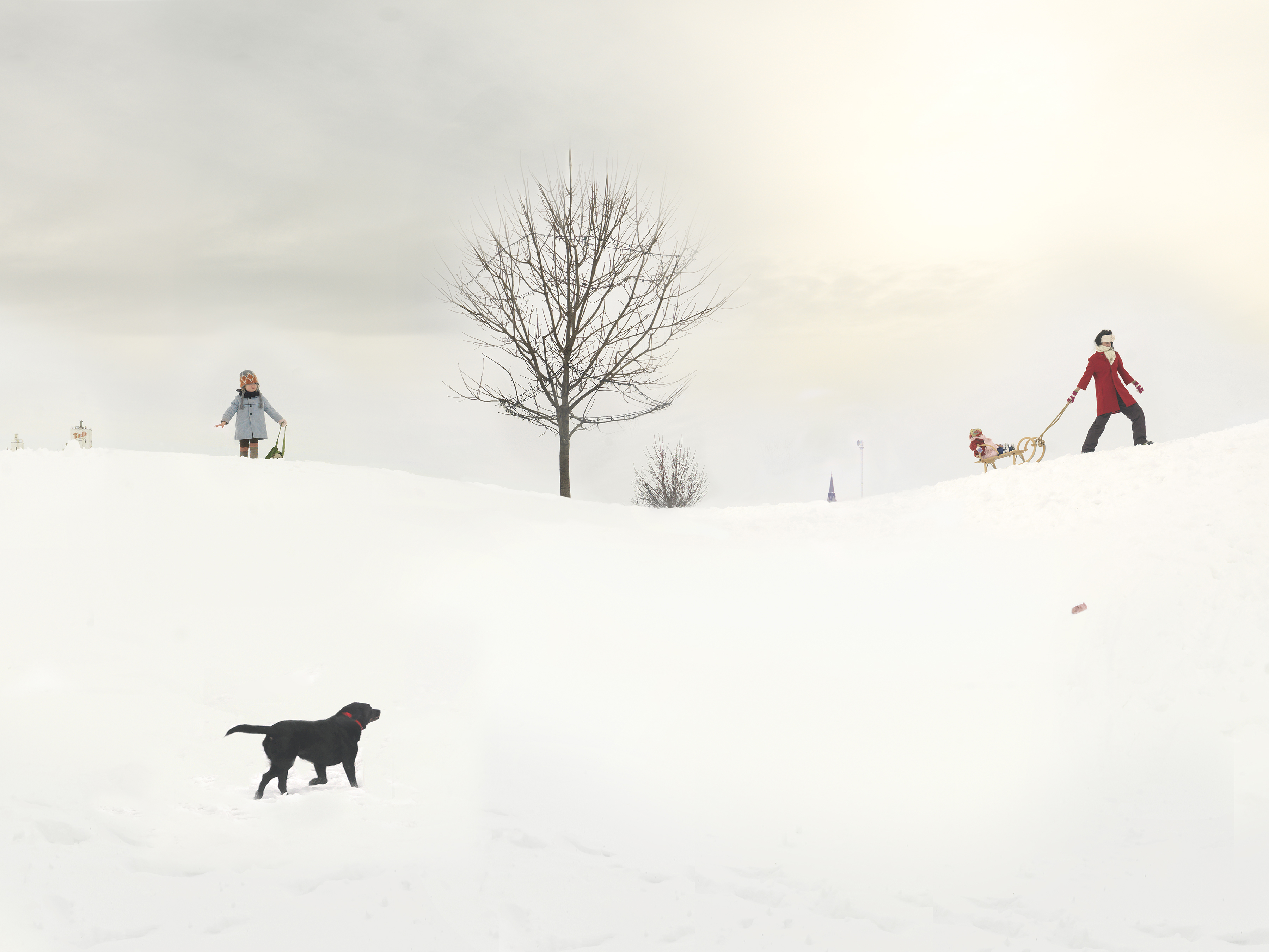 A snowy landscape with figures scattered across a white field. A bare tree stands in the center, while a person in a blue coat holds a basket on the left, another in a red coat pulls a sled with a child on the right, and a black dog walks in the foreground. The composition is minimal and serene, with muted tones against the expansive white snow.