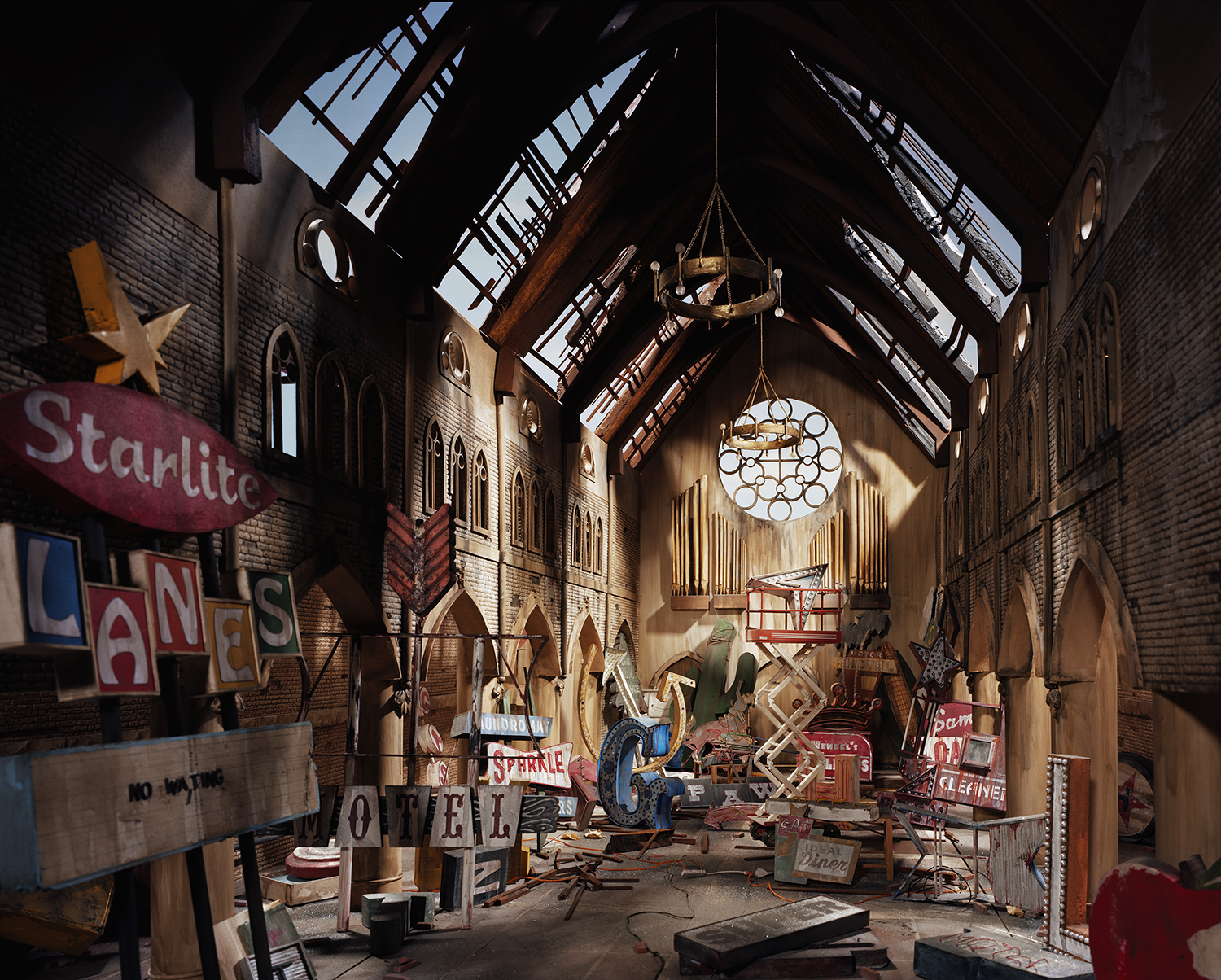 A derelict brick church interior bathed in dramatic natural light from skylights above. Vintage signage, musical instruments, and scattered debris fill the nave beneath a circular chandelier, creating a surreal tableau of abandonment and decay.