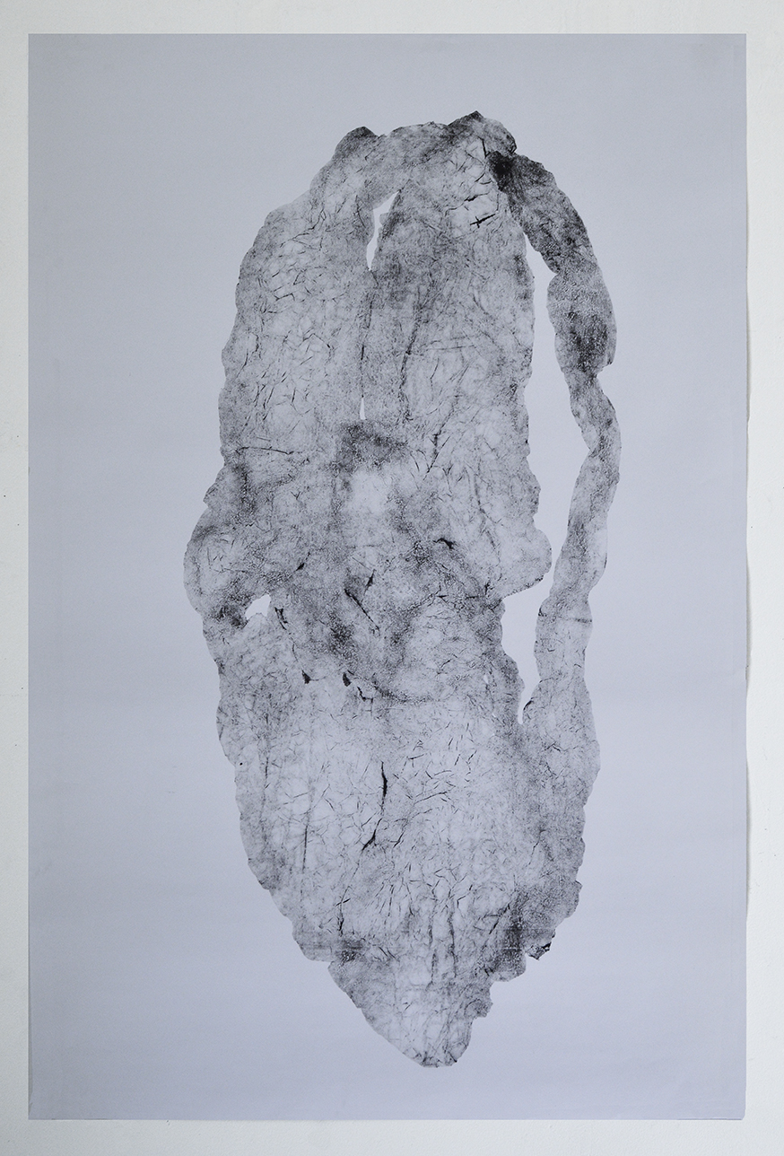 A vertical monoprint in grayscale depicting an abstracted, columnar form with a textured surface of fine lines and organic marks. The pale composition emerges from a light gray background, its irregular edges and darkened areas creating depth and dimensional quality across the elongated shape.