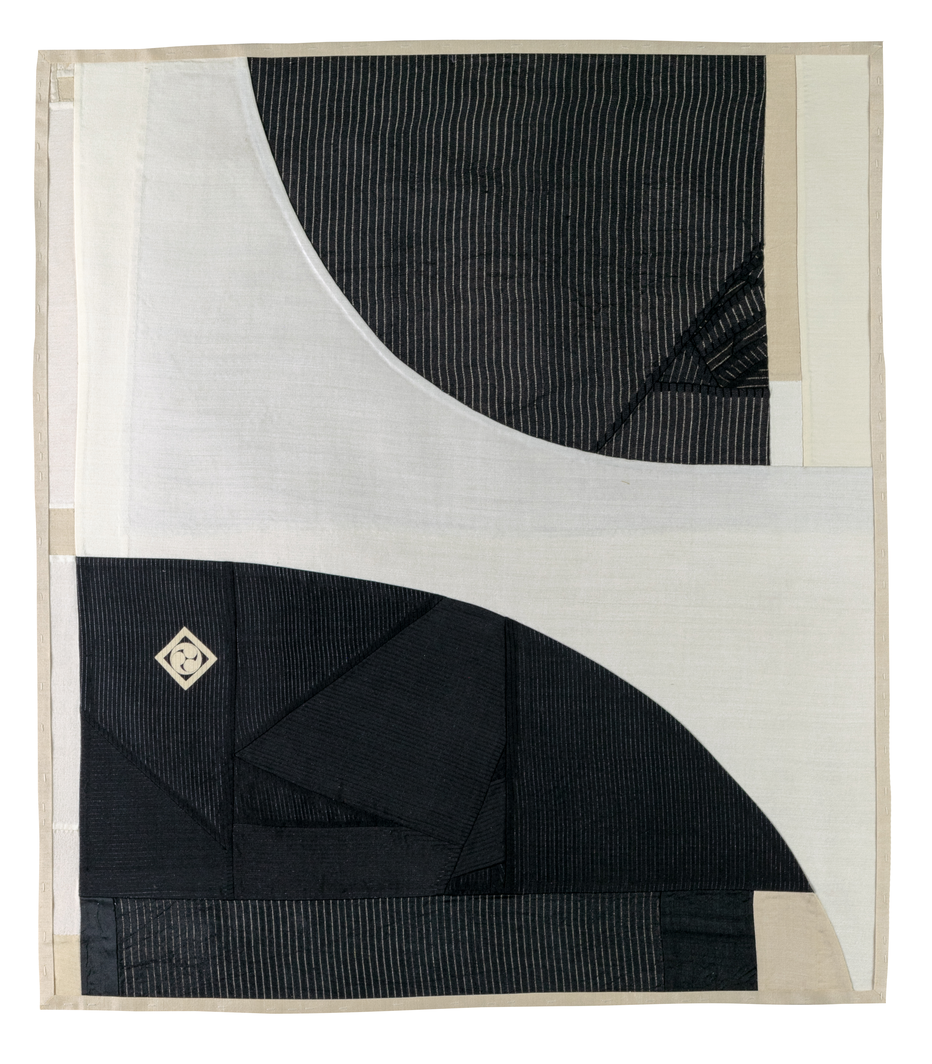 Pieced vintage silk textile featuring abstracted curved forms in black and cream tones. Vertical pinstripes create visual texture across the dark sections, while smooth cream fabric provides contrast, with a small diamond-shaped emblem detail visible on the lower left portion.