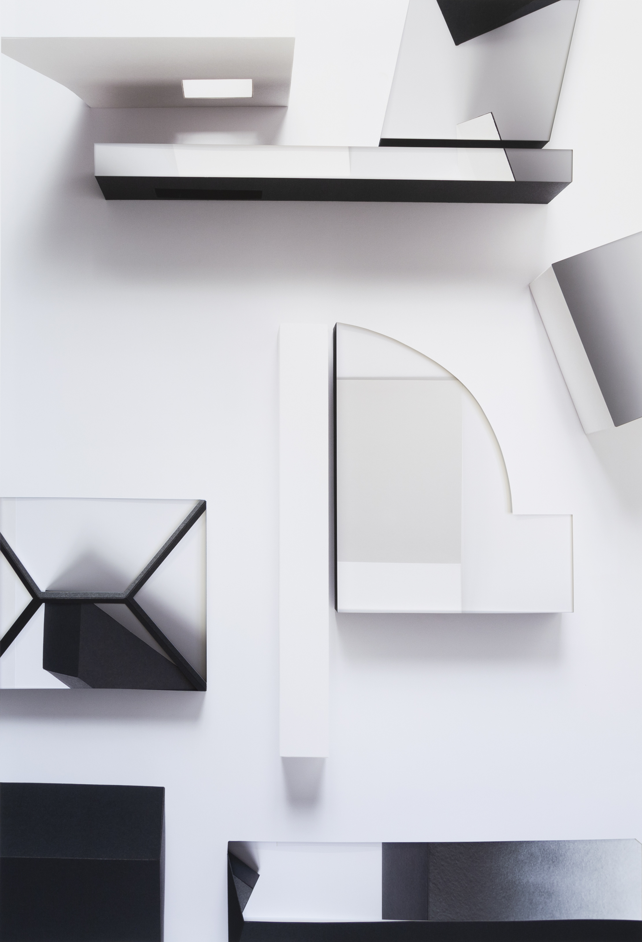 Abstract composition of layered geometric forms in black and white, featuring overlapping rectangular and curved shapes arranged across a light background. Shadowing and depth create a three-dimensional effect suggesting deconstructed architectural elements.