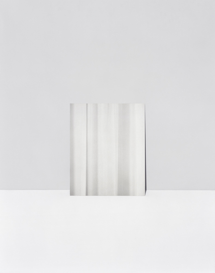 A minimalist composition featuring vertical folds or pleats of white and light gray material against a neutral gray background, creating subtle gradations of tone and shadow through gentle gradients and soft light.