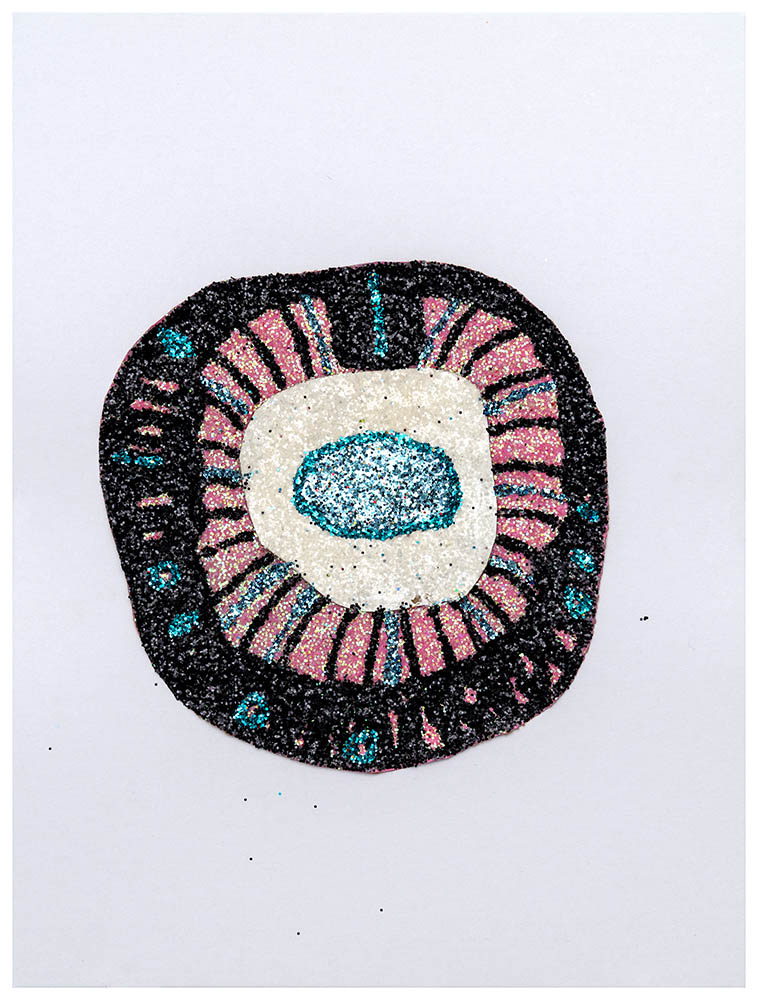 A concentric circular composition featuring a turquoise glitter eye at the center, surrounded by radiating pink and black glittered sections, with a cream-colored ring creating definition between layers. The iridescent glitter creates a shimmering, textured surface against a pale background.