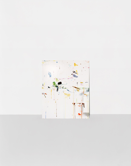 Abstract composition featuring scattered geometric shapes and organic forms in muted yellows, greens, blues, and earth tones arranged across a predominantly white background, creating a sense of dispersed movement and spatial depth.